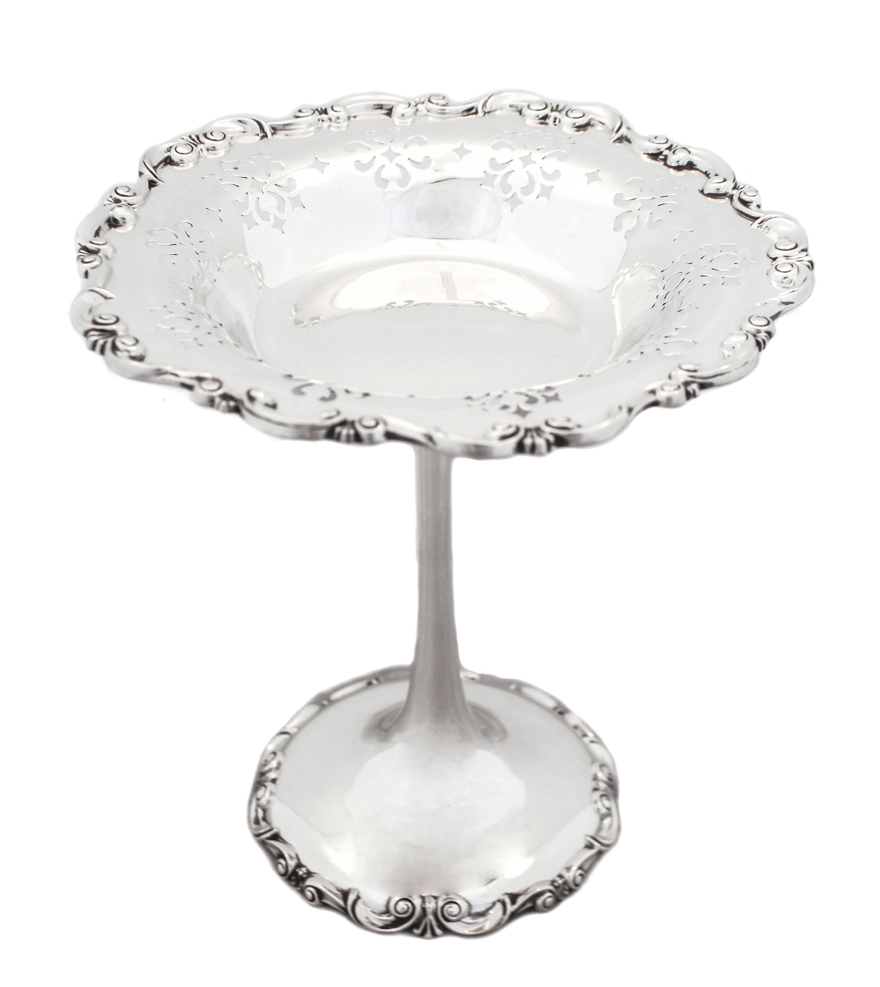 Being offered is a pair of sterling silver compotes by Towle Silversmiths. They have a scalloped rim and base with a gadroon design wrapping around the border. There is also a decorative cutout design around the top. These compotes are extra tall