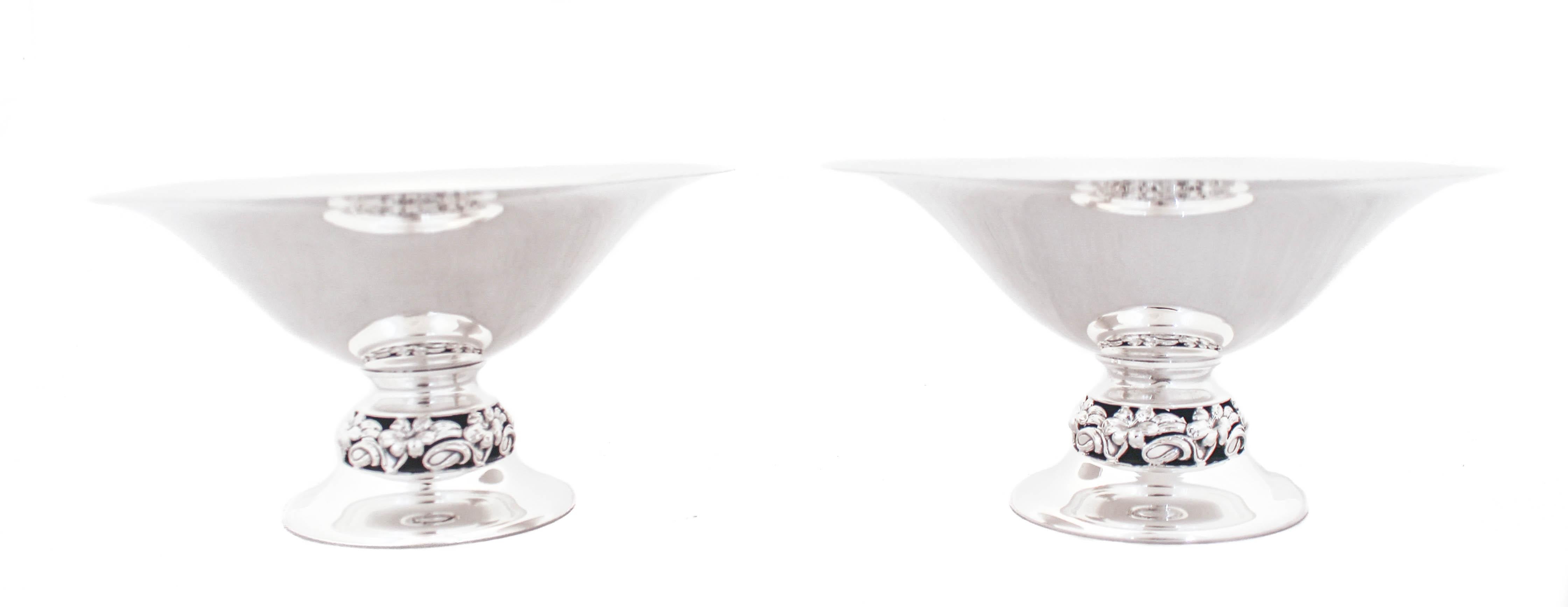 Being offered is a pair of sterling silver compotes by the Mueck-Cary Silver Company.  They have a floral design around the base that gives these otherwise sleek and modern compotes a little personality.  These are perfect to have on your coffee