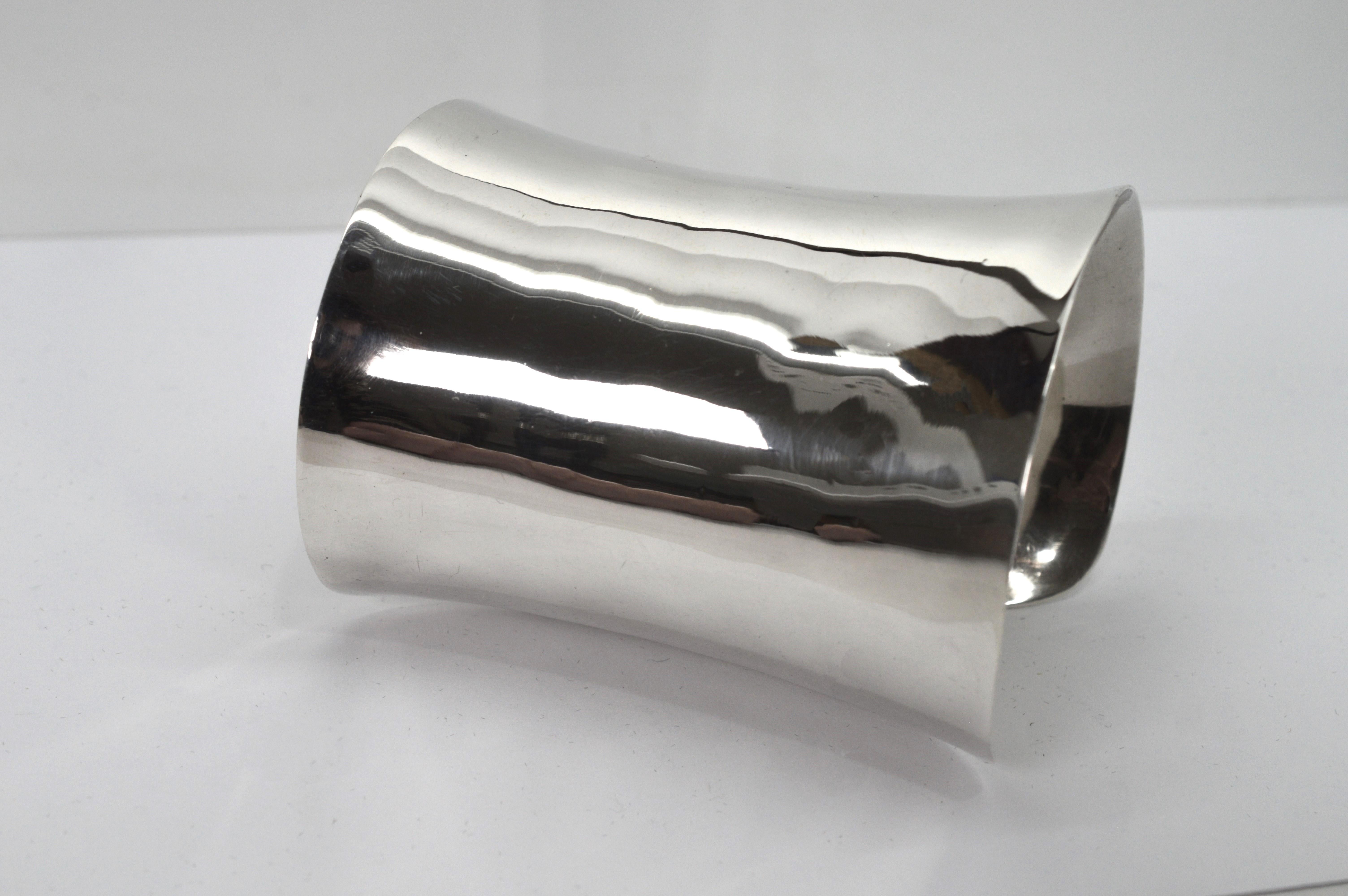 This fabulous high polished long cuff bracelet defines bold style. In sculpted sterling silver, the sleeve measures a generous three inches long and wraps the wrist with a modern contoured shaped 2-1/2 x 2 inches wide. The piece has some flex to