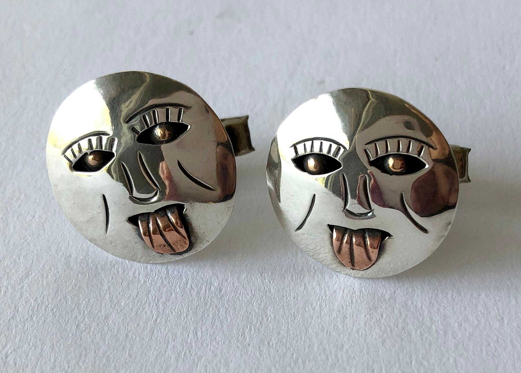 Mexican modernist sterling silver cufflinks with open eyes, big grin, playfully sticking out its tongue.  Cufflinks measure 1