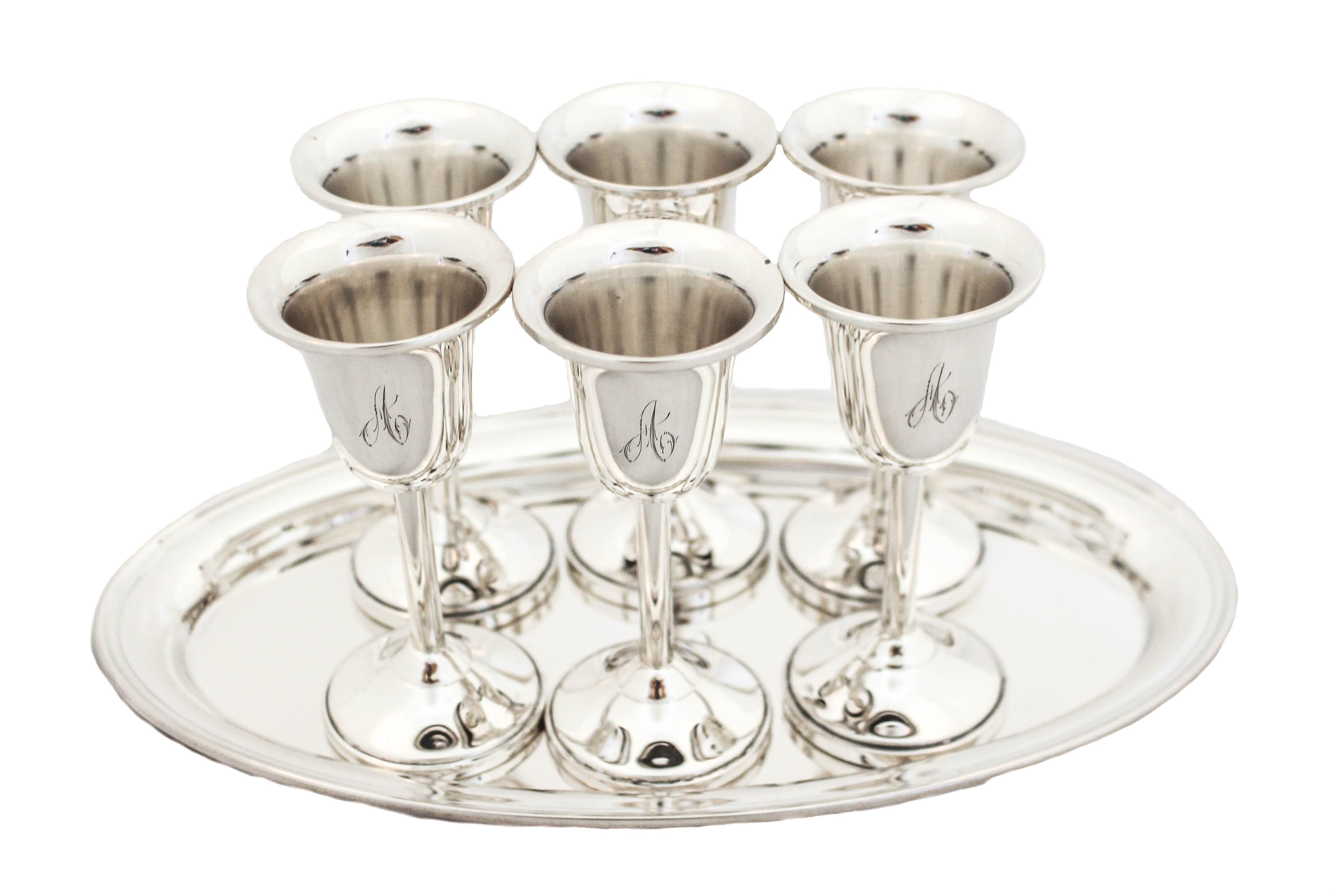 Being offered is a set of six sterling silver cordials and tray.  Manufactured at the height of the Mid-Century modern movement, the set is contemporary and sleek.  The curves on the cups and tray are “soft” and have a more casual feel.  There are