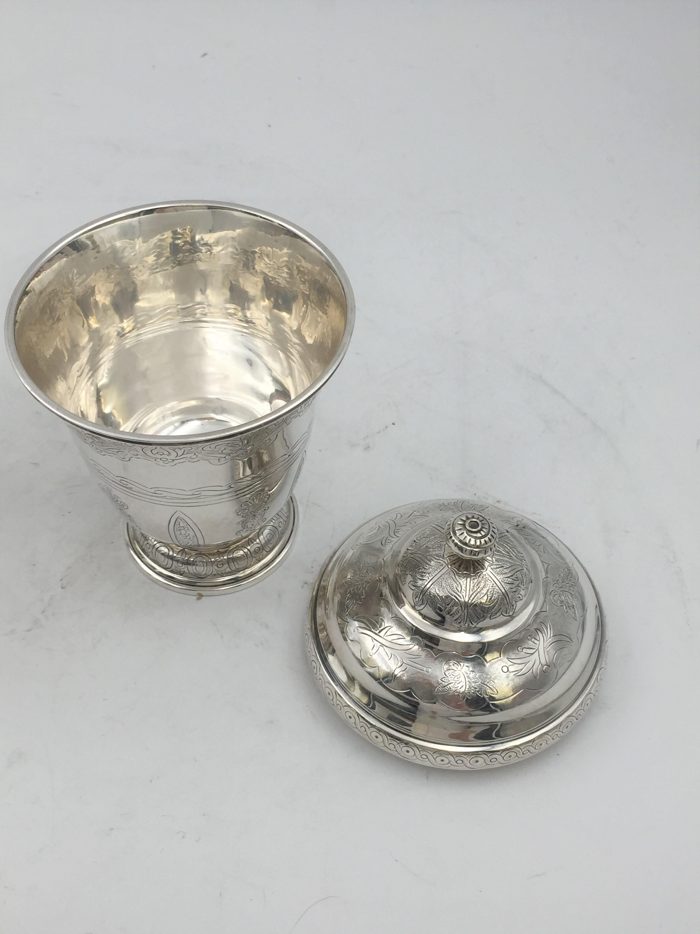 Sterling silver, engraved covered Kiddush cup / beaker finely engraved with spiral finial atop by Tane. Measuring 7'' in height and 3 7/8'' in diameter. Weighs 11.5 ozt. Bearing hallmarks as shown.
Tane has been established in Mexico City since the