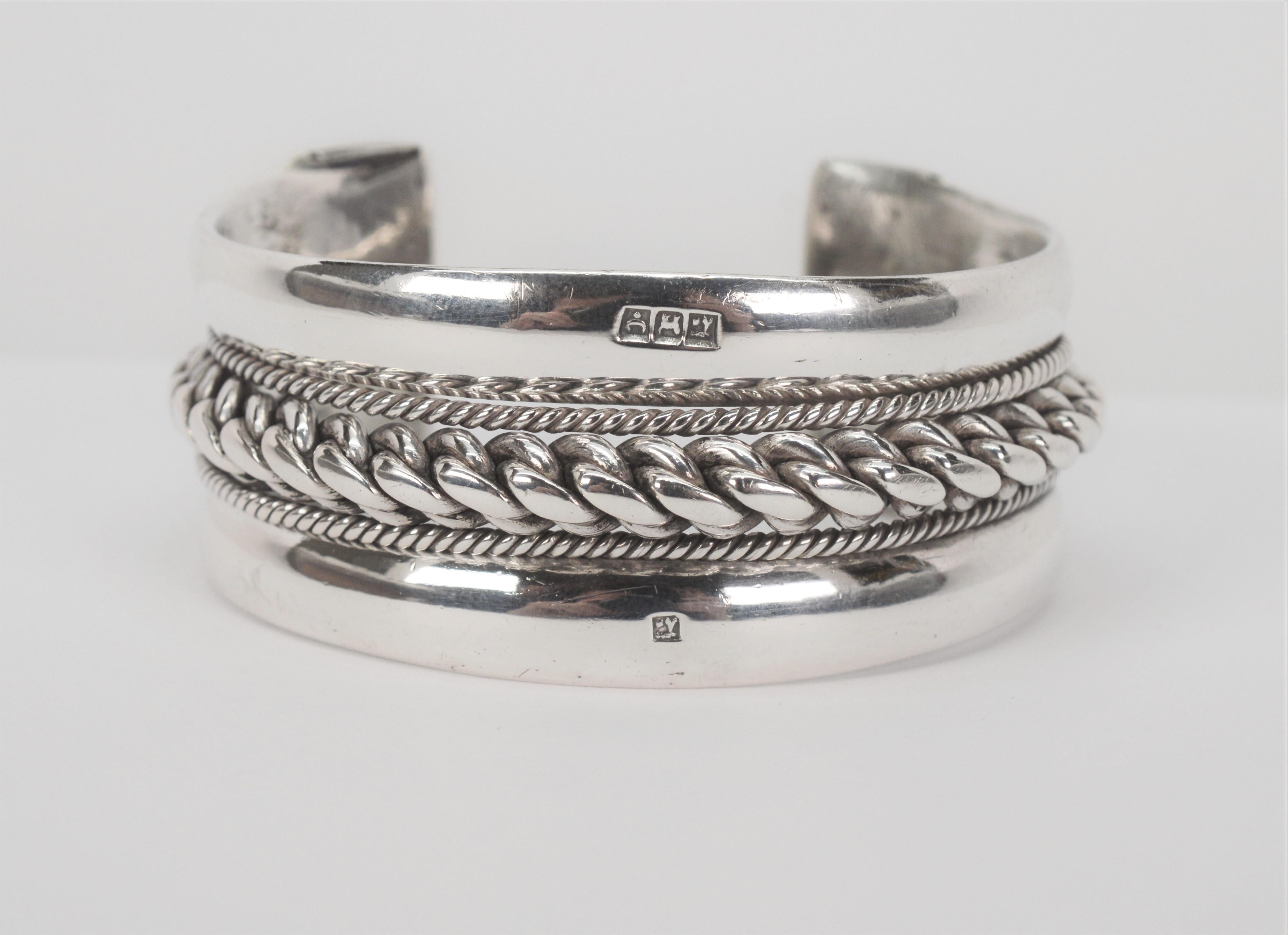 Notably well hand crafted heavy gauge .925 Sterling Silver Cuff Bracelet with Egyptian artisan hallmarks. A bold raised twisted rope detail dominates and is accented with smaller braided trim all hand crafted in sterling silver. The outer rim of the