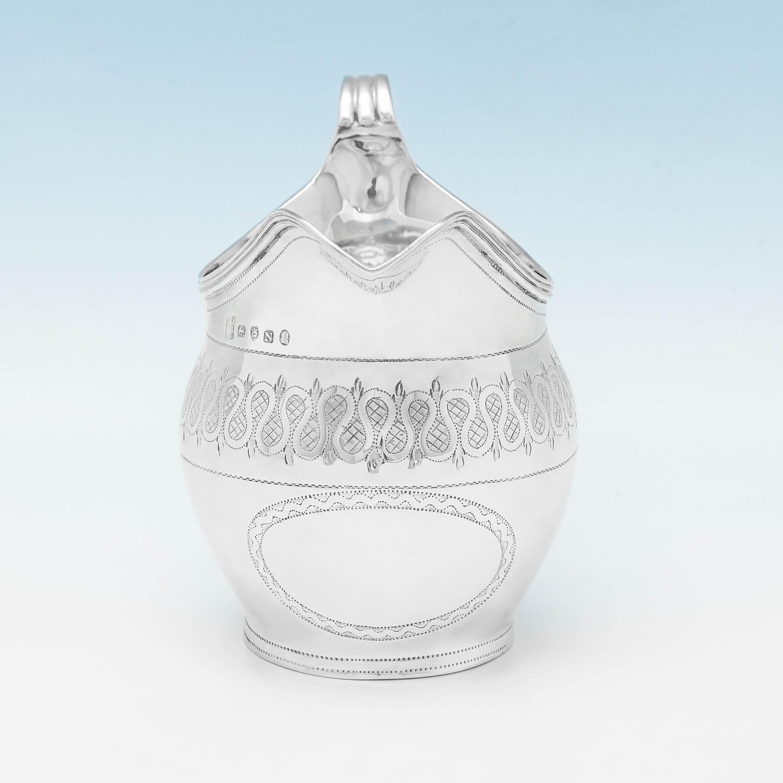 Hallmarked in London in 1808 by Godbehere, Wigan, & Bult, this fine, antique, George III, sterling silver cream jug, has a band of engraving around the body, reed borders, and a vacant cartouche. The cream jug measures 4