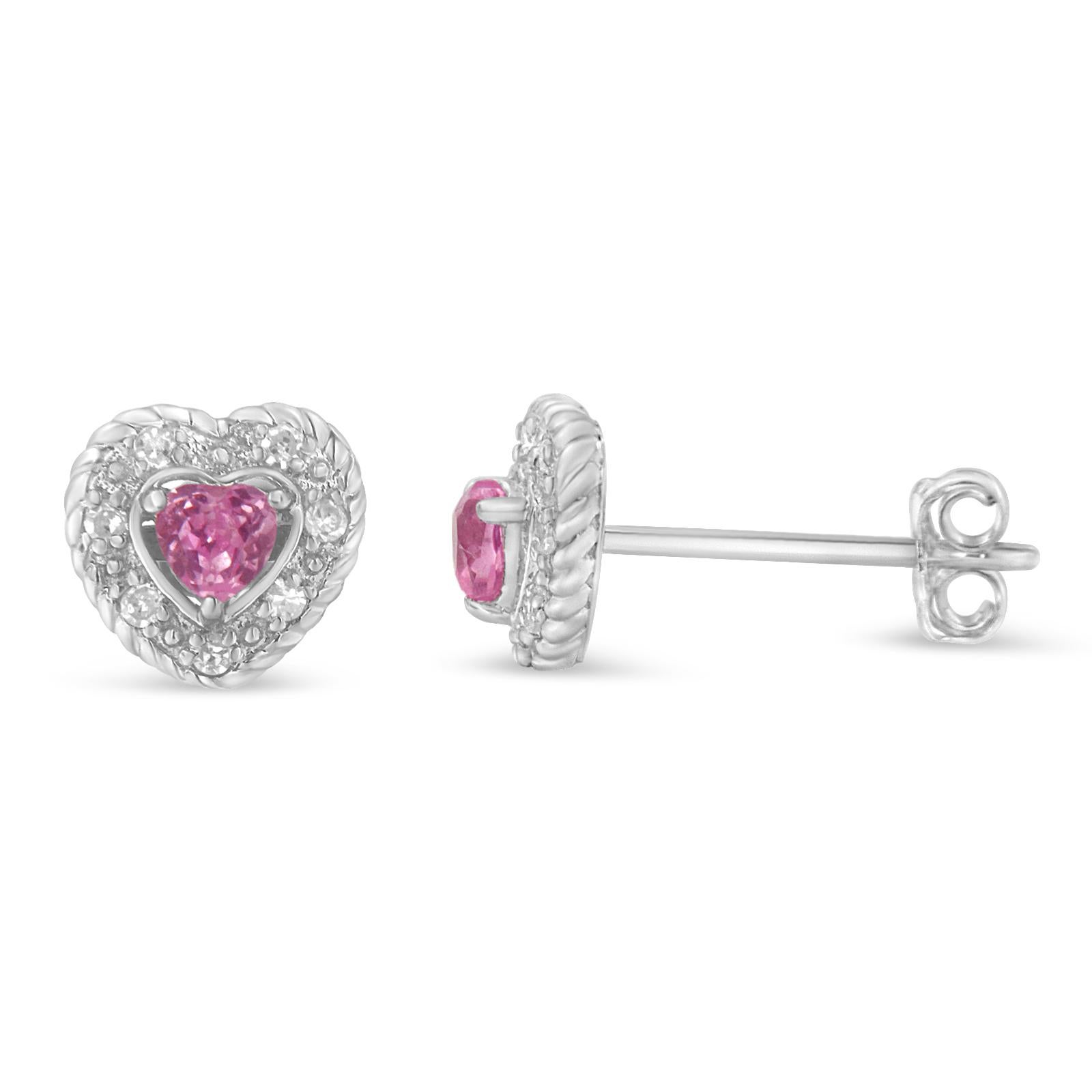 Bound to turn heads, this luminous pair of stud earrings is graced with rich sterling silver. Dazzling in pink sapphire, the heart-shaped earrings captivate the grand mystique. Surrounded by the halo of glittering diamonds, the earrings amalgamate