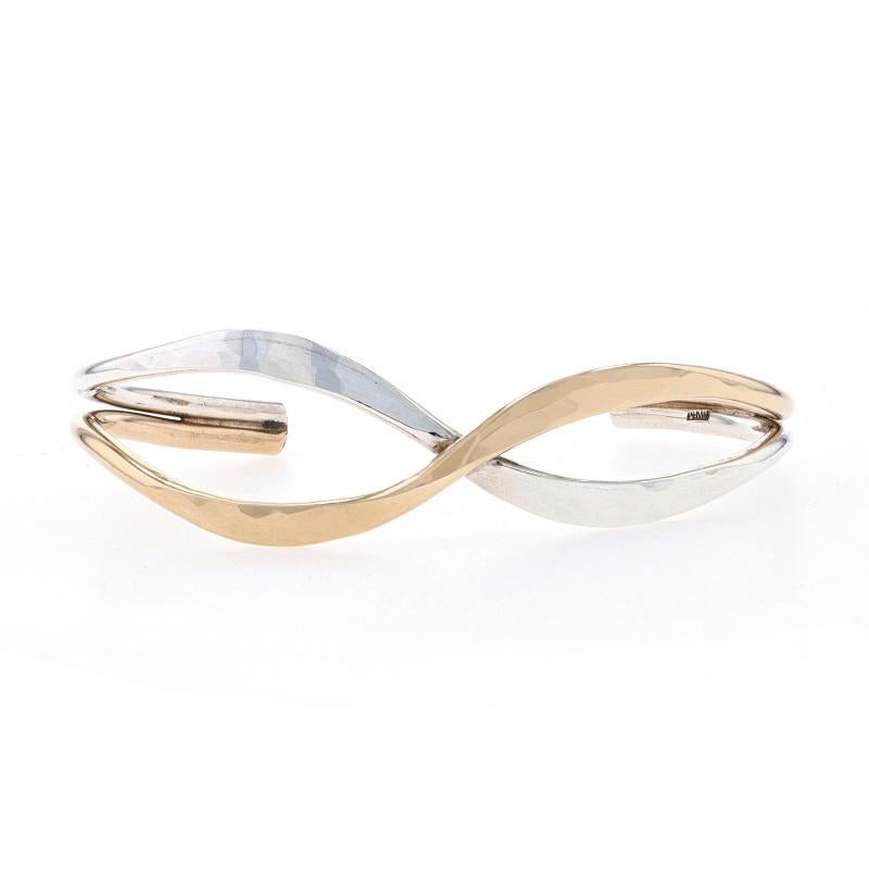 Metal Content: Sterling Silver & 14k Yellow Gold Filled

Style: Crossover Cuff
Fastening Type: N/A (slides over wrist)
Features: Smoothly Finished with Lightly Hammered Detailing

Measurements
Inner circumference (including the opening): 6