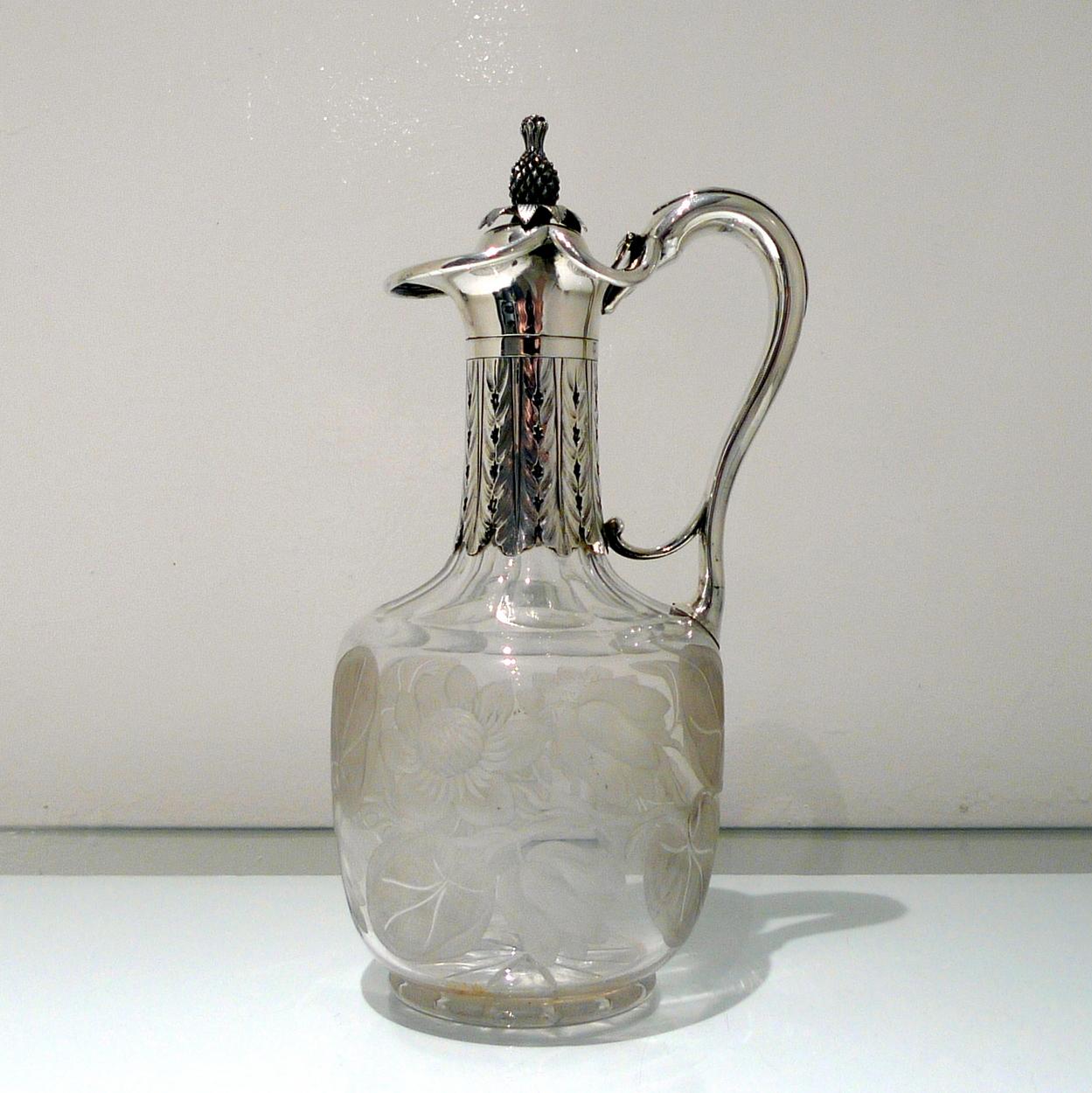 An unusual Victorian silver claret jug decorated with an ornate silver mount and a lower floral engraved crystal bowl. The lid is hinged and is mounted with a stylish silver “pineapple” finial.

 

Height: 30 inches/12 inches

Length: 6