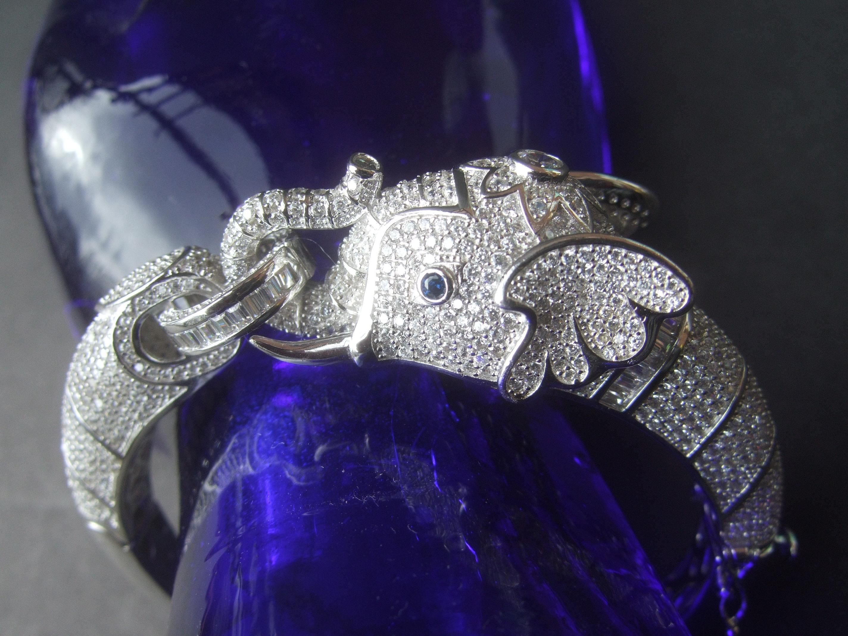 Exquisite sterling silver crystal encrusted hinged elephant bangle 
The majestic elephant figure is embellished with intricate rows of contiguous tiny diamante crystals

The elephant's eyes are distinguished with tiny sapphire blue color crystals.
