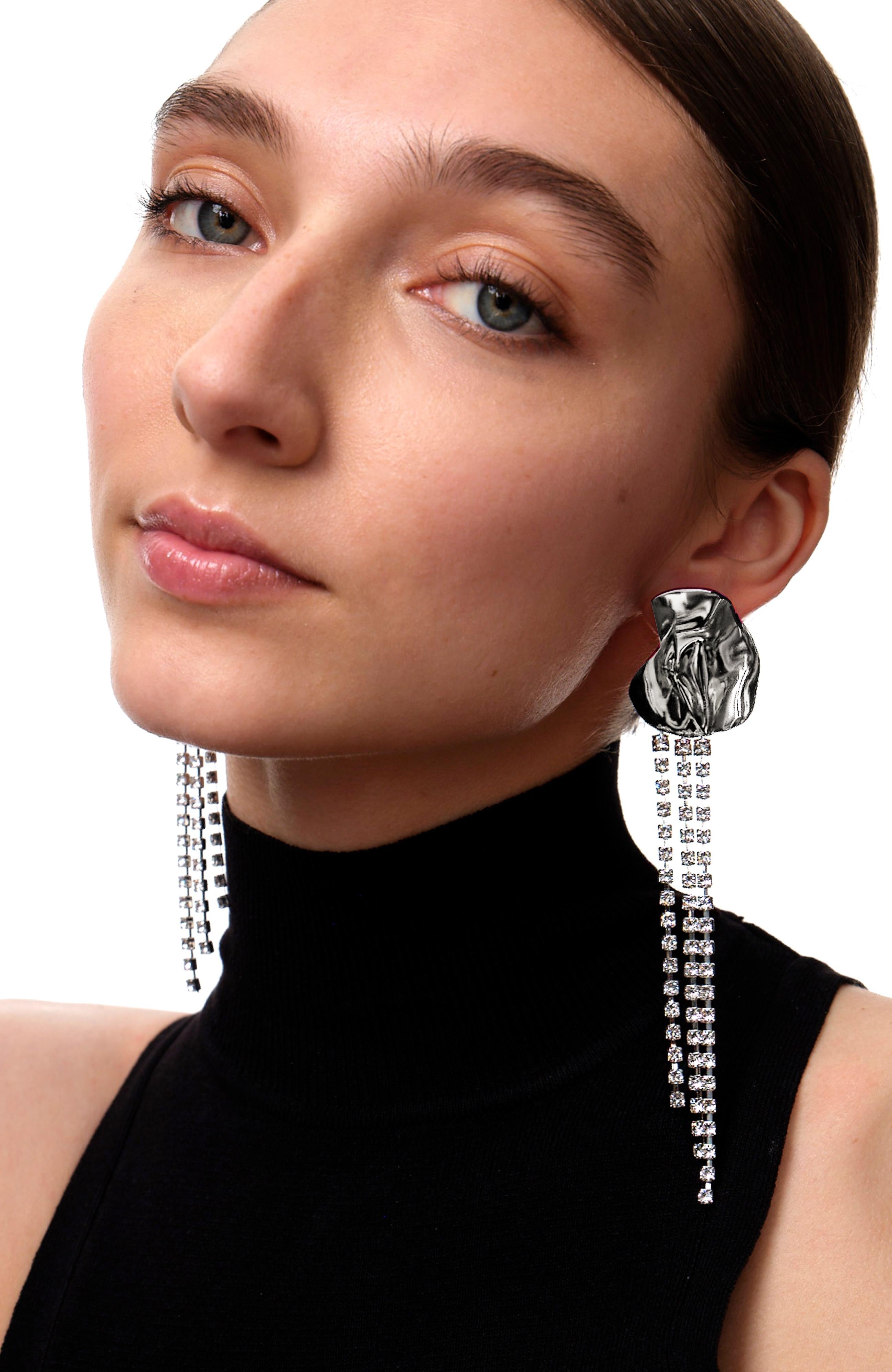 The Georgia crystal-embellished earrings from Sterling King feature a sculptural shape embellished with cascading clear crystals. Inspired by the works of Georgia O'Keeffe, these floral-inspired earrings are cast in sterling silver. Lightweight and