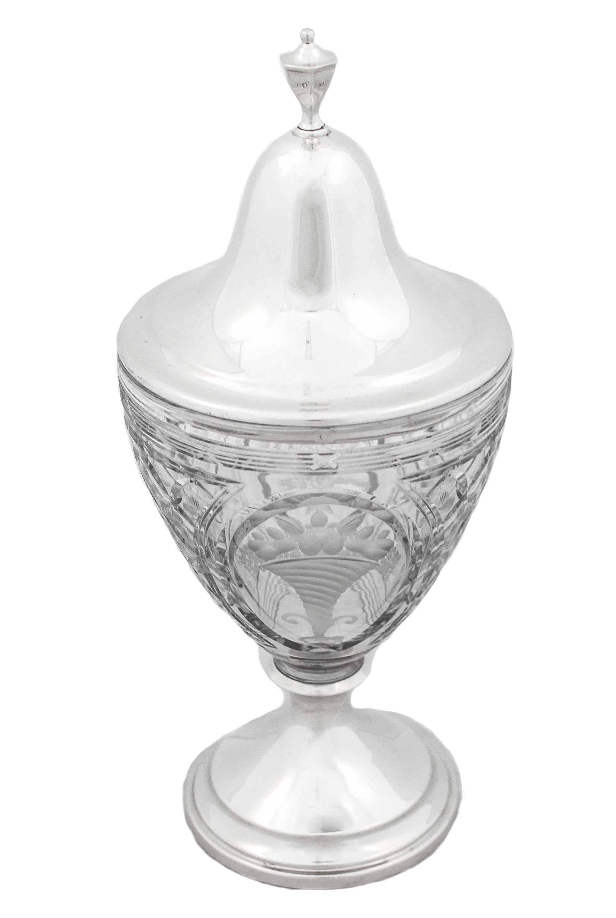 We are delighted to offer you this sterling silver and crystal urn by Frank Whiting Silver Company.  The pedestal and lid are both sterling silver while the urn is cut glass in a diamond pattern.  There is on both sides of the urn acid etched