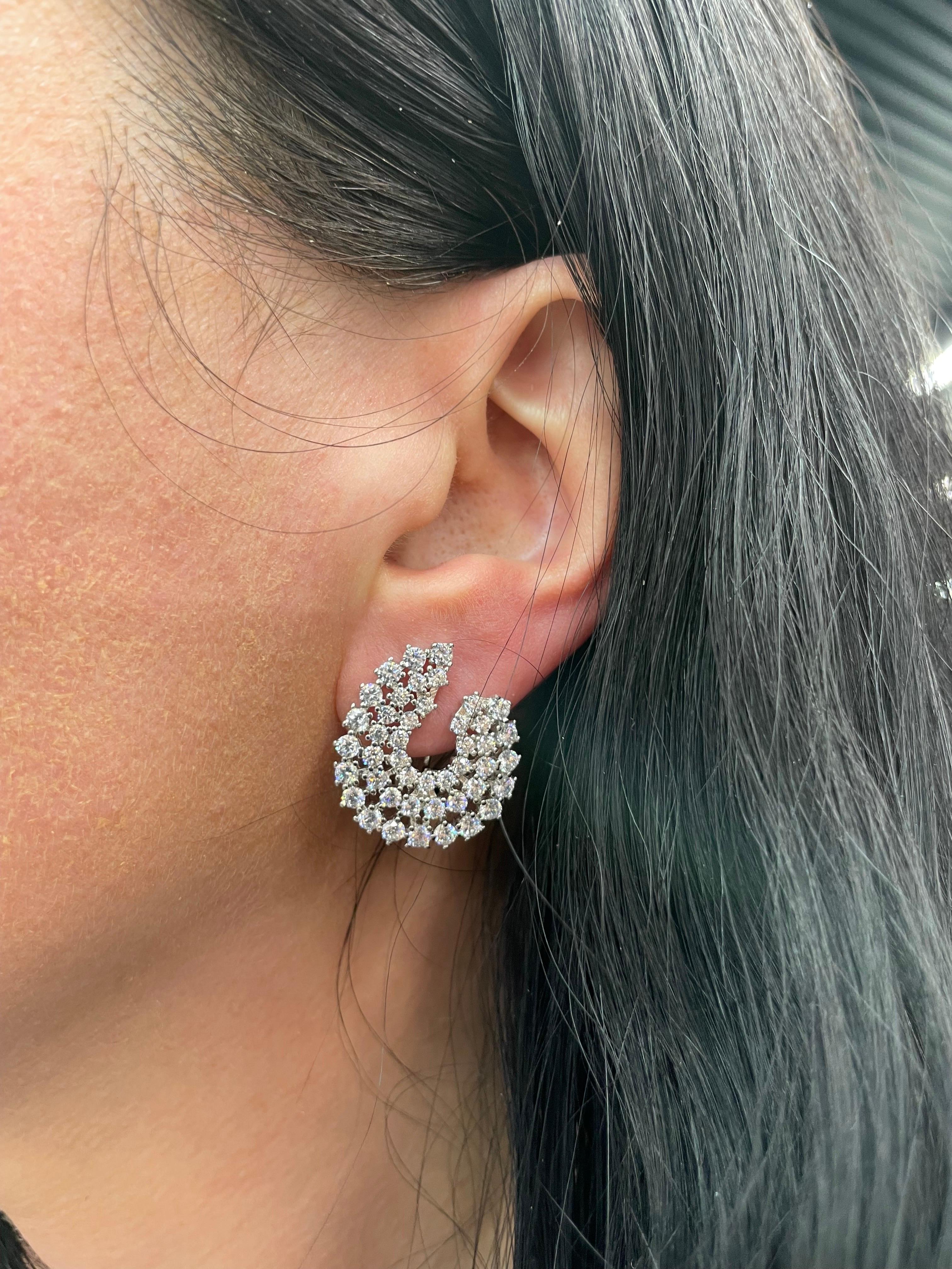 Rhodium plated sterling silver earrings featuring three rows of Cubic Zirconia in a U shape design.
Will not tarnish, high quality sterling silver. 
Dimension 23 mm long x 20.6 mm wide x 3.2 deep