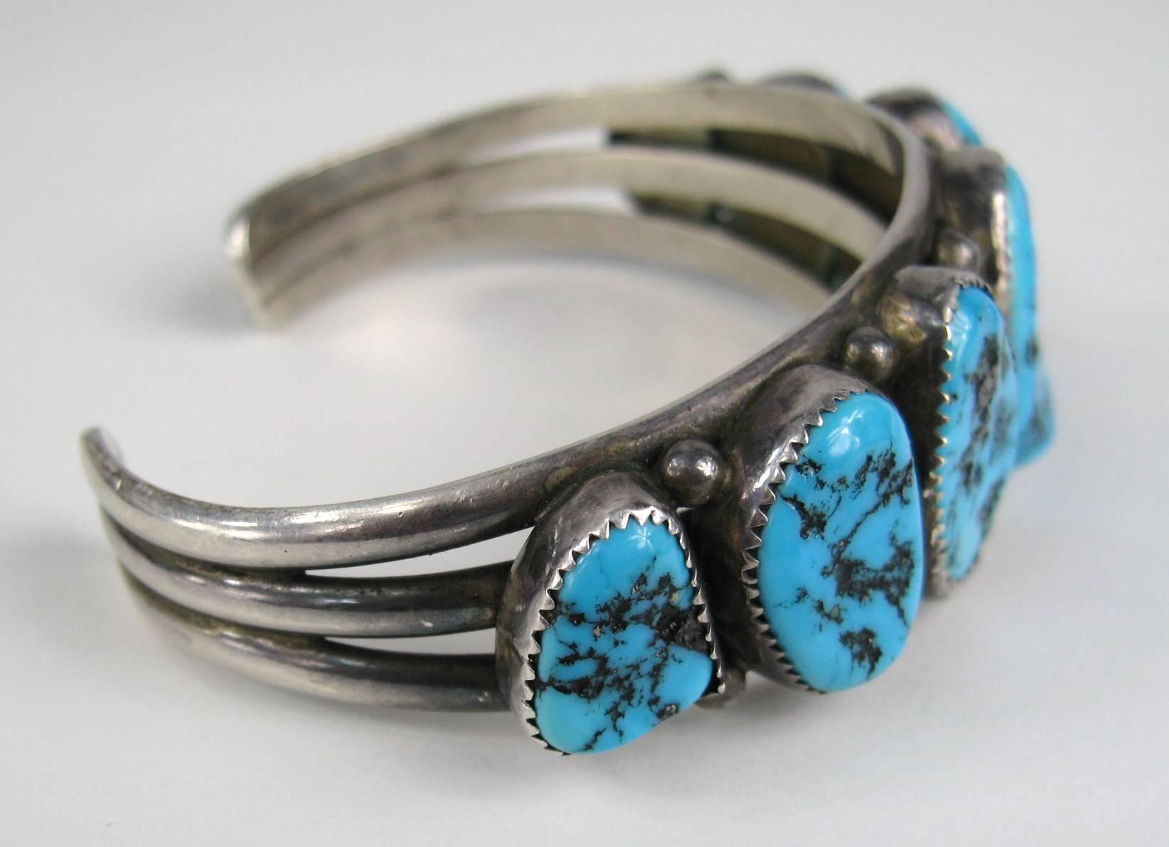 Hand crafted Sleeping Beauty Navajo Sterling silver bracelet. 3 Rings makes up the bracelet with 7 bezel set Turquoise stones set in a graduated fashion. This can be worn by both a man or woman Measuring 1 inches at it widest 1.45 in. opening Will