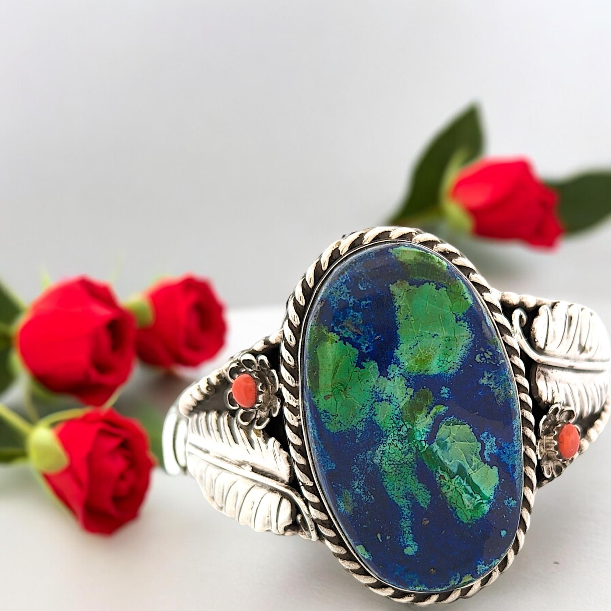 This captivating cuff bracelet is a stunning convergence of natural elements, crafted from gleaming sterling silver. The centerpiece takes center stage, a mesmerizing combination of azurite and malachite gemstones. Azurite, with its deep blue hues