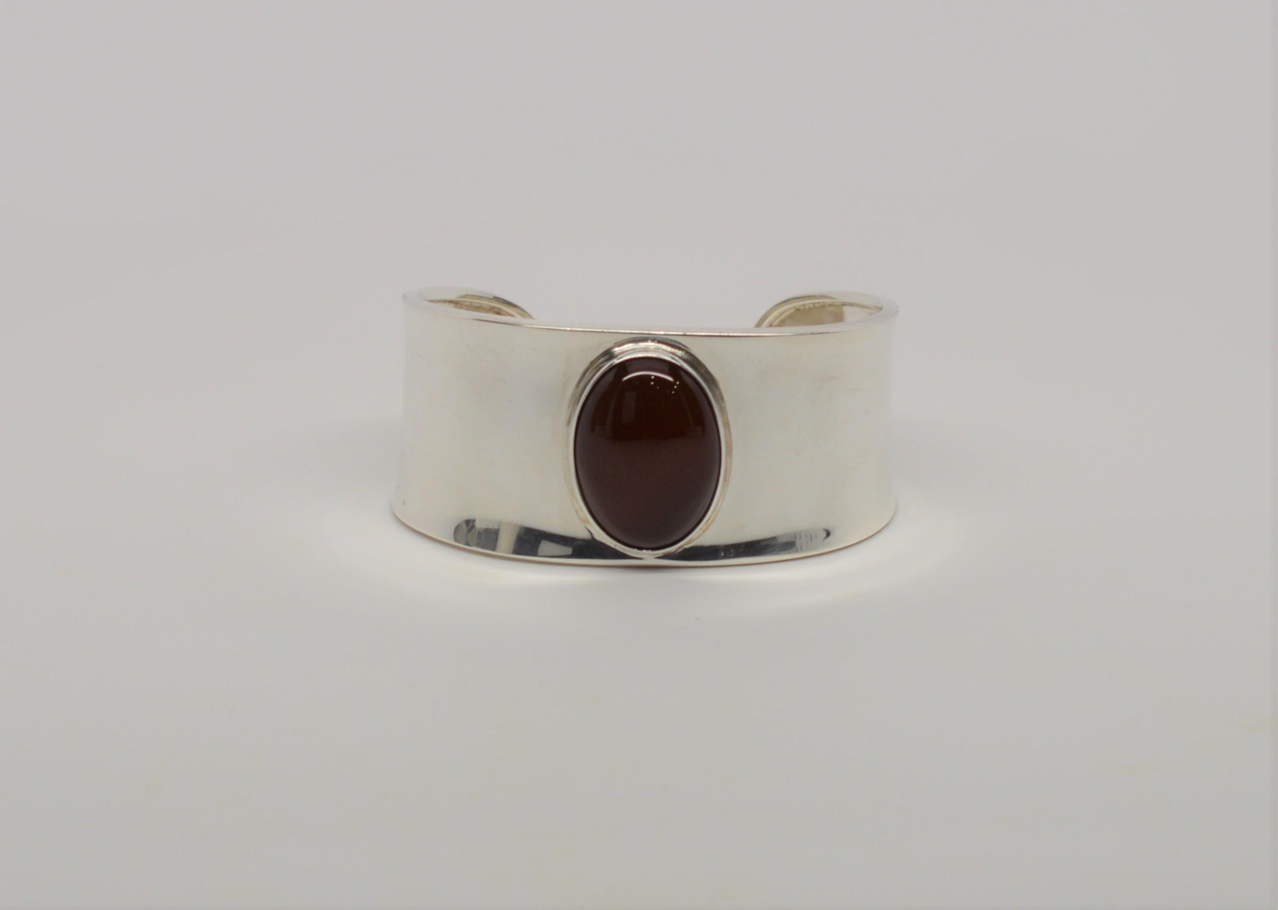 Beautiful Sterling Silver Cuff Bracelet with feature Red Coral Center Stone from our Estate Collection. The Cuff measurements graduate from approximately 1 inch to 1-1/8 inch at the widest center point. The rich red Coral Cabochon Stone measures