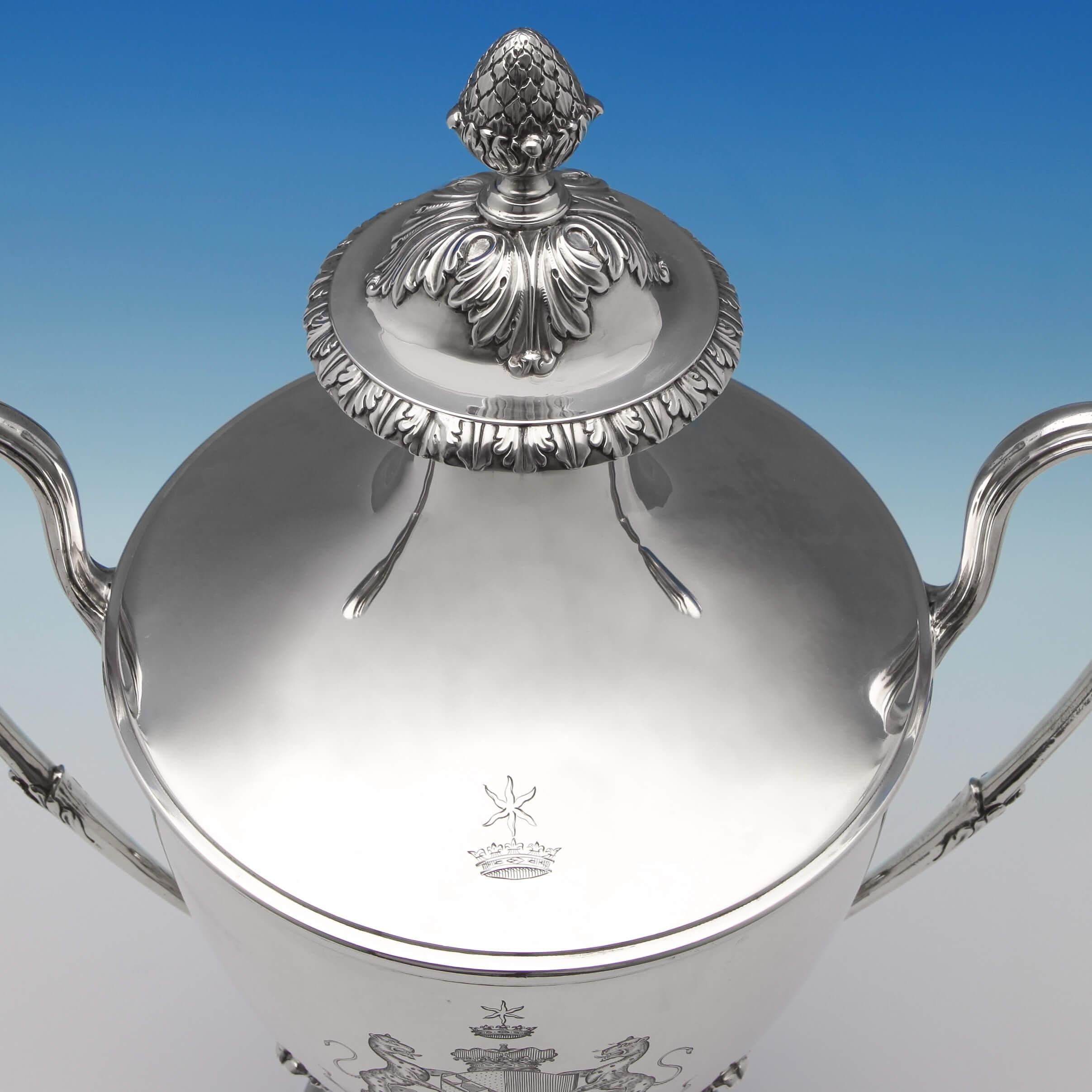 Hallmarked in London in 1773 by Charles Wright, this striking, antique George III, sterling silver cup and cover, features reed detailed loop handles and applied acanthus decoration. The cup bears an original engraved coat of arms for John Frederick