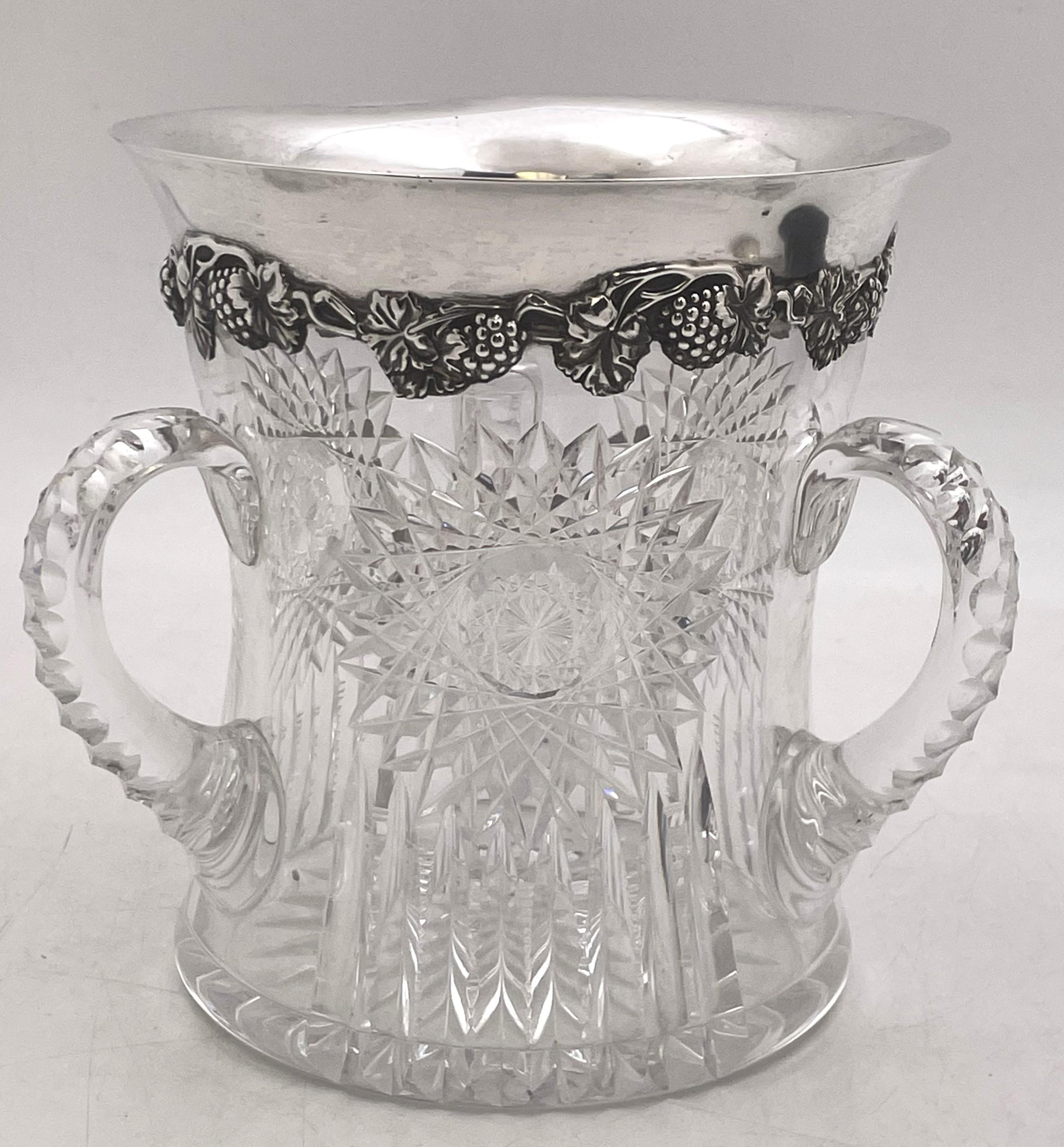 Sterling silver and cut-glass wine cooler or loving cup, in Art Nouveau Style with exquisite raised natural motifs adorning the rim, and from the early 20th century. It measures 7'' in height by 6 1/3'' in diameter at the top by 7 1/4'' from handle