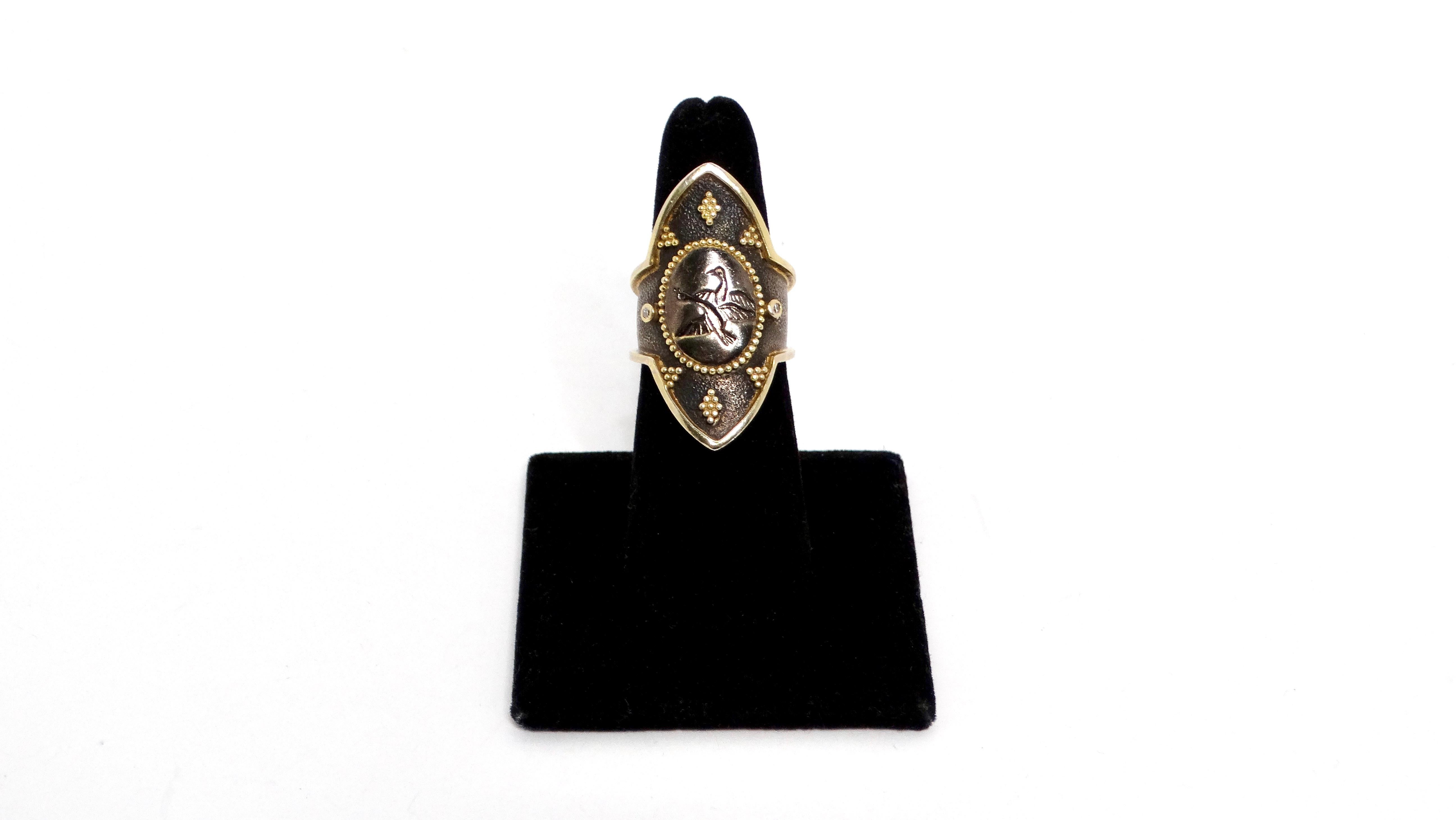 Presenting the Sterling Silver Dancing Swans Shield Ring that features and intricate designer with two swans gracefully poised in a shield-shaped face. Crafted from 925 sterling silver, the ring boasts elegant gold-plated accents and is further