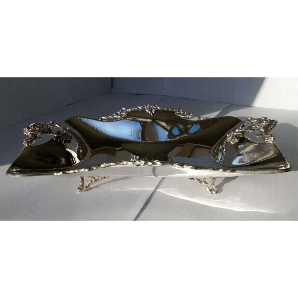 Sterling Silver Decorated Rectangular Dish

In excellent condition, this is a beautiful piece. It stands on four delicate, embossed feet with lovely intricate decoration as handles and on the edges.

Hallmarked: 925. There are no maker or date