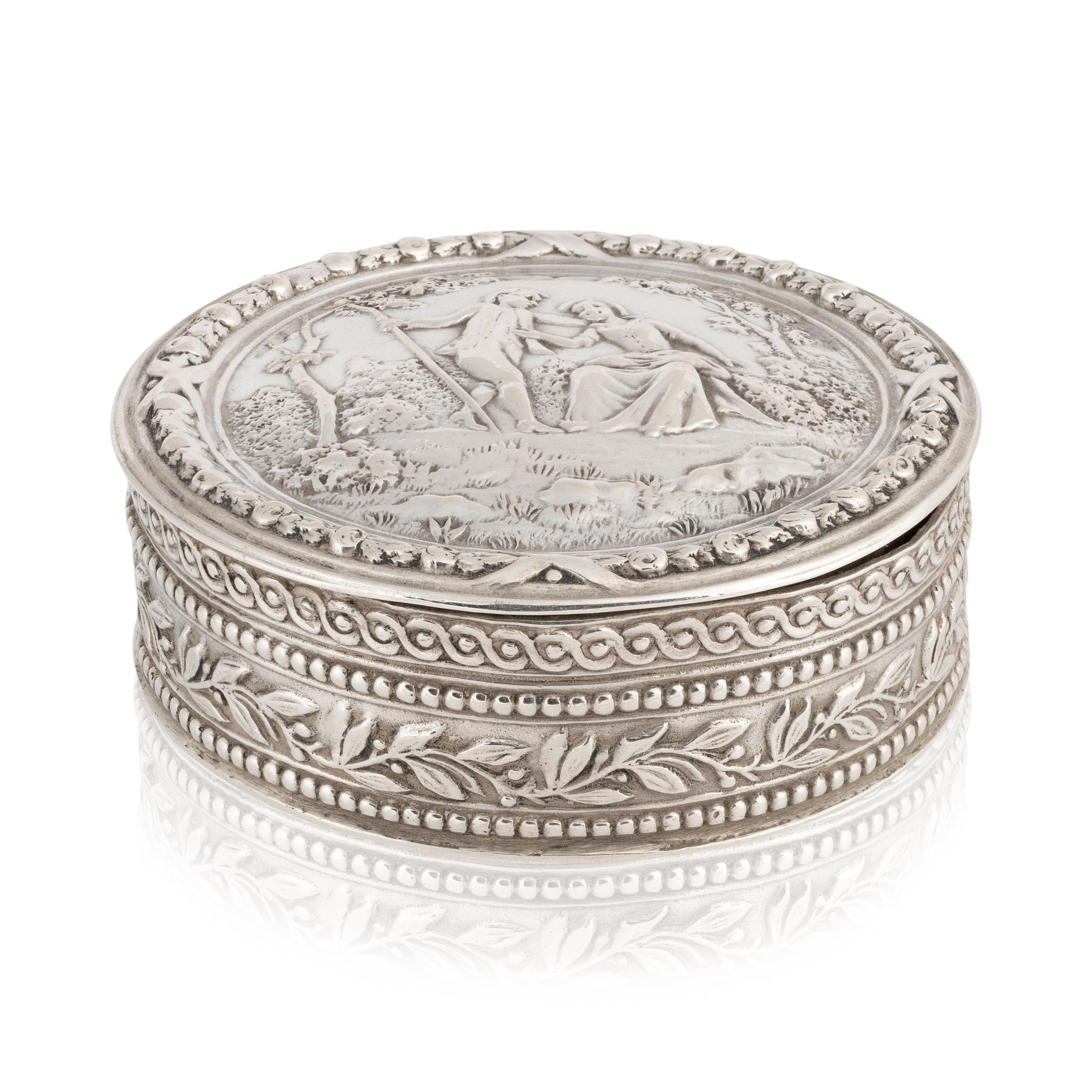 Eight sided silver lidded box with decorated sides and courting scene. Bottom marked 