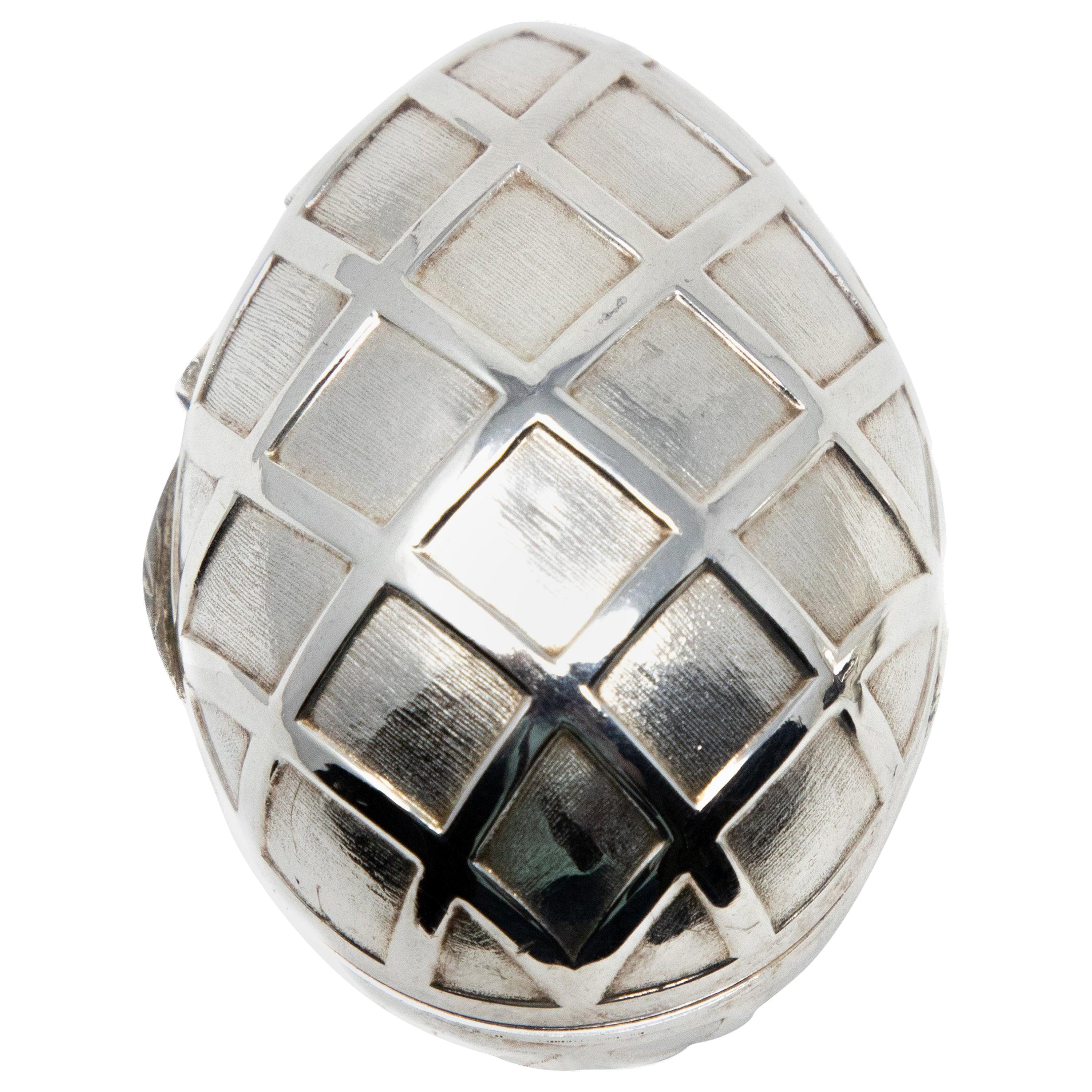 Offering this stunning sterling silver decorative egg. This egg is done in a geometric diamond pattern all-over the body. It is hinged and does open and has a latch. The inside you can see the diamond pattern reversed. It is marked 925, and sterling