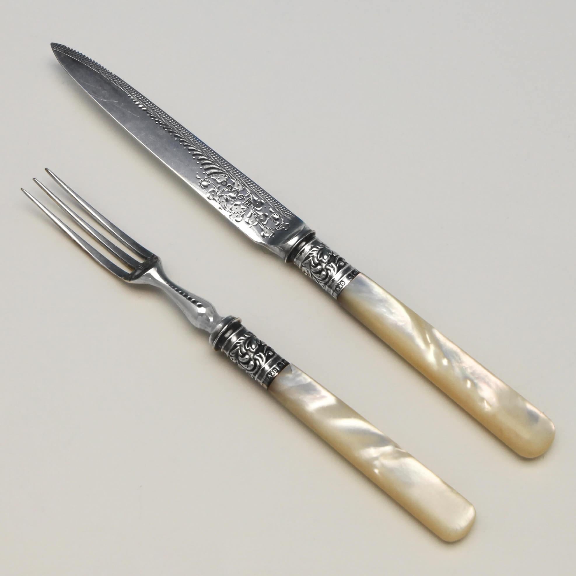 Hallmarked in Sheffield in 1911 by Allen & Darwin, this stunning, Victorian, antique sterling silver dessert set, features mother of pearl handles, engraved silver plated blades and tines, chased sterling silver ferrules, and is presented in a