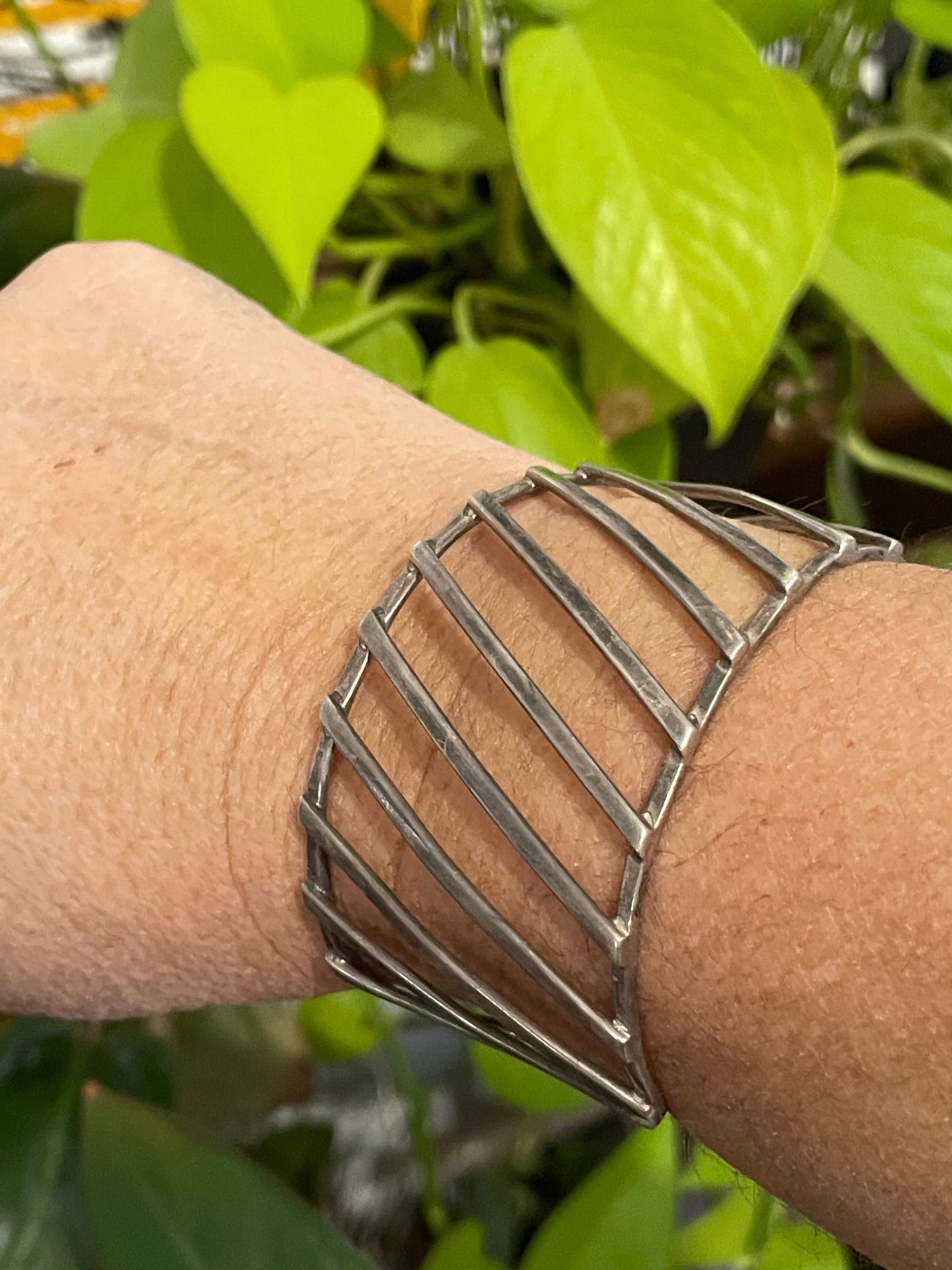 Wide sterling silver Modernist Bracelet. Diagonal motif. Hallmarked on the in of the cuff. This is shown on a wrist that is 6.5