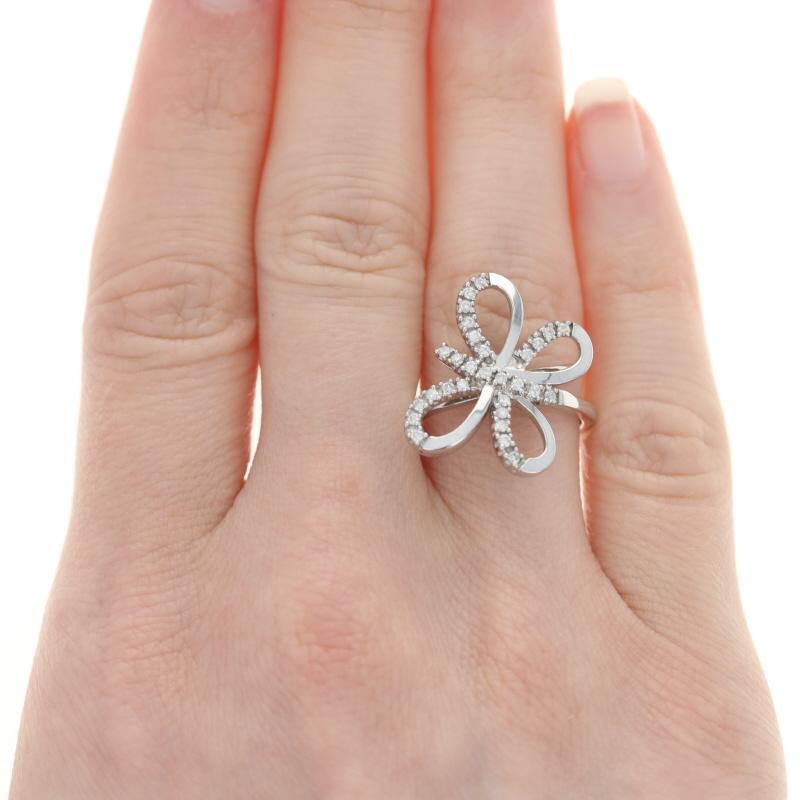 This lovely sterling silver ring is in the shape of a beautiful butterfly. The butterfly has shimmering .37ctw diamonds lining its wings. The shimmering diamonds are a I - J color with I1 - I2 clarity. You can find the metal purity mark on the