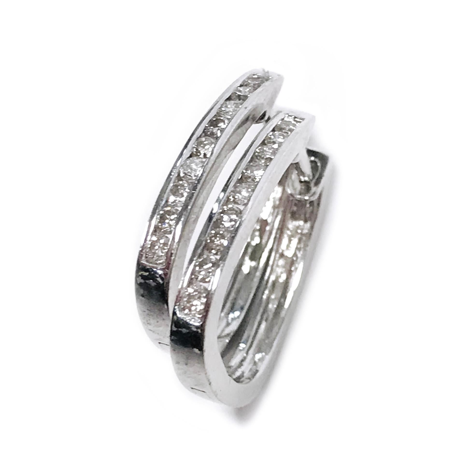 Sterling Silver Diamond Hoop Earrings. The petite earrings feature nine 1.5mm channel-set brilliant-cut round diamonds on each earring. The diamonds are SI1-SI2 (G.I.A.) in clarity and J-K (G.I.A.) in color. The total carat weight of the earrings is