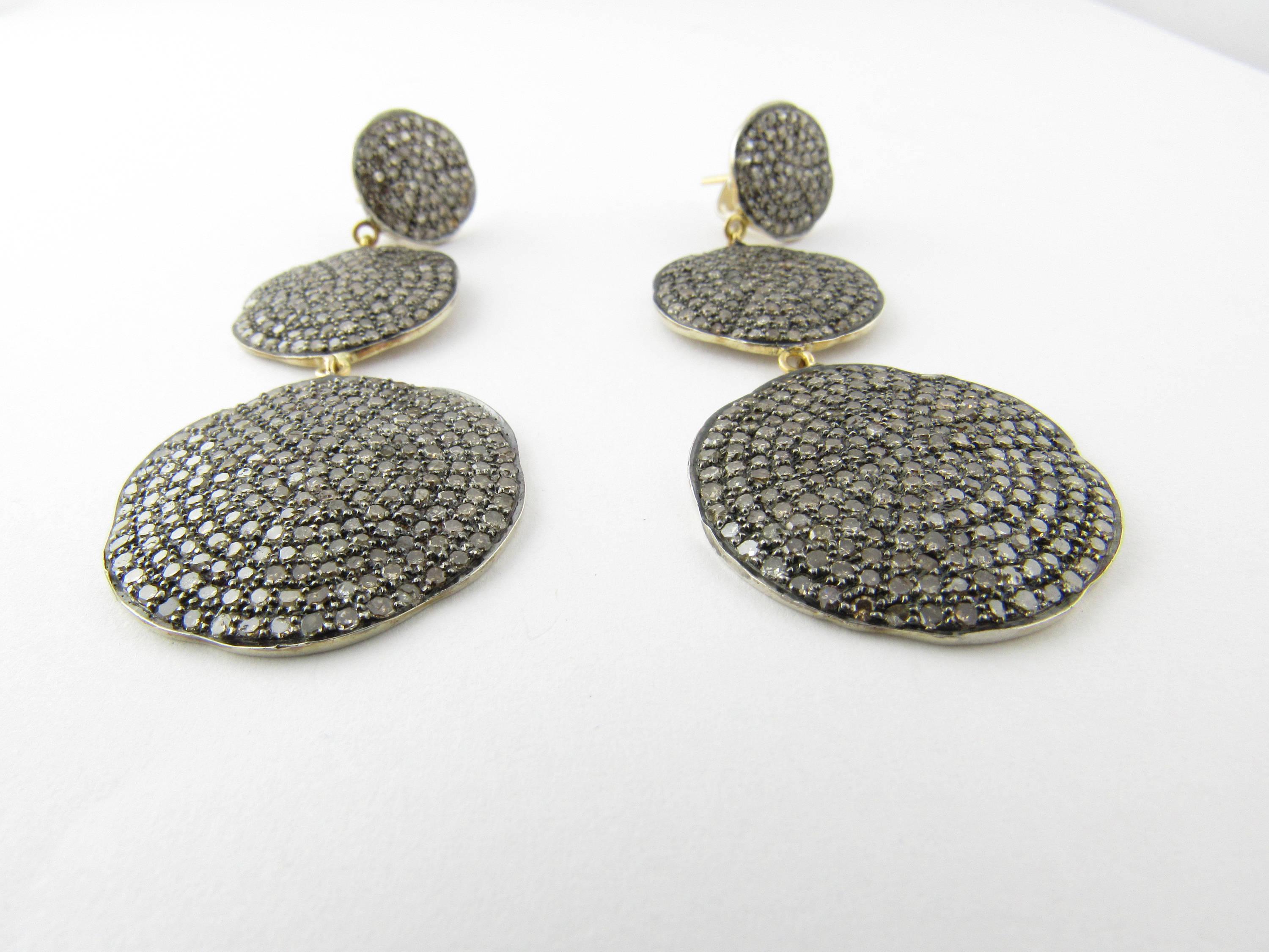 Vintage Sterling Silver Diamond Pave Dangle Earrings 
These gorgeous dangle earrings each feature 299 single cut diamonds pave set in three vertical sterling silver discs (12 mm, 18 mm, 25 mm). Beautifully designed. 
Approximate total diamond