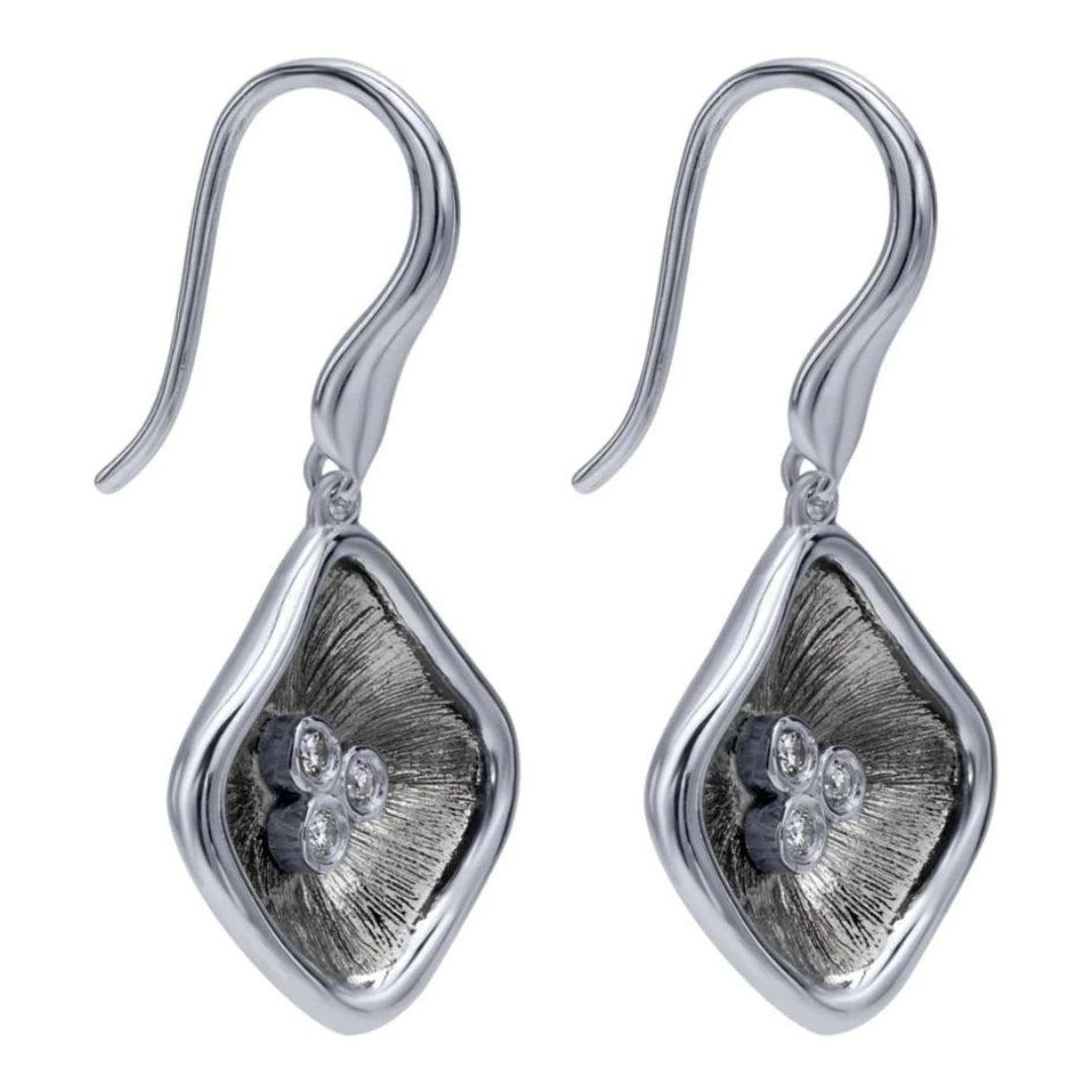 Sterling Silver, Diamonds and Black Rhodium Drop Earrings. Contrasting colors and exquisite texture showcase a cluster of bezel set round white diamonds. Total diamond weight is 0.06 ctw. Rhodium finish for tarnish free maintenance.