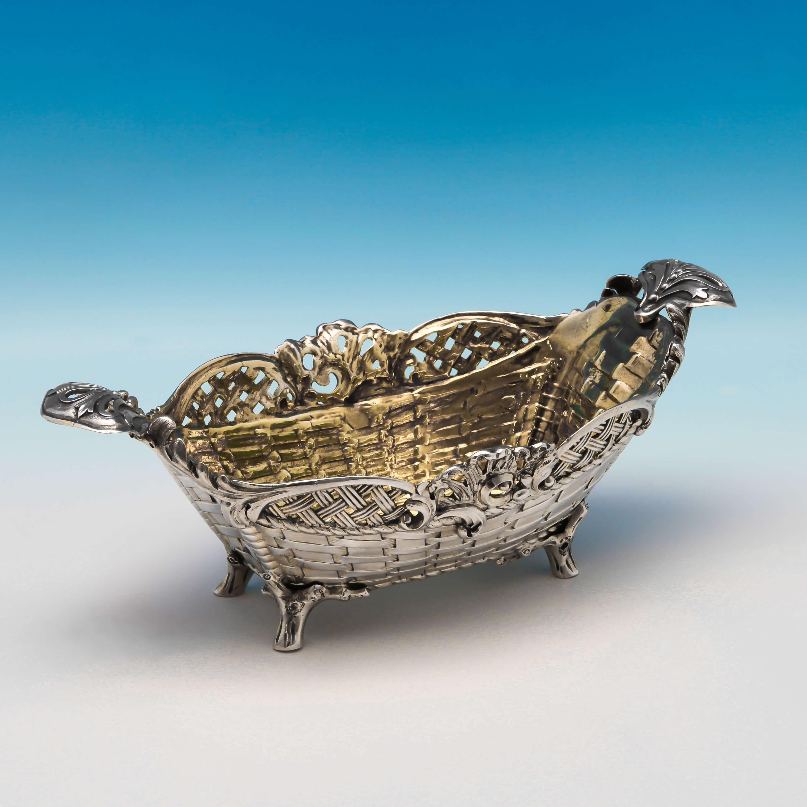 Hallmarked in London in 1880 by Stephen Smith, this attractive, Victorian,antique, sterling silver dish, has pierced lattice work and basket weave decoration, cast shell and scroll detailing, naturalistic feet and and a gilt interior. The dish