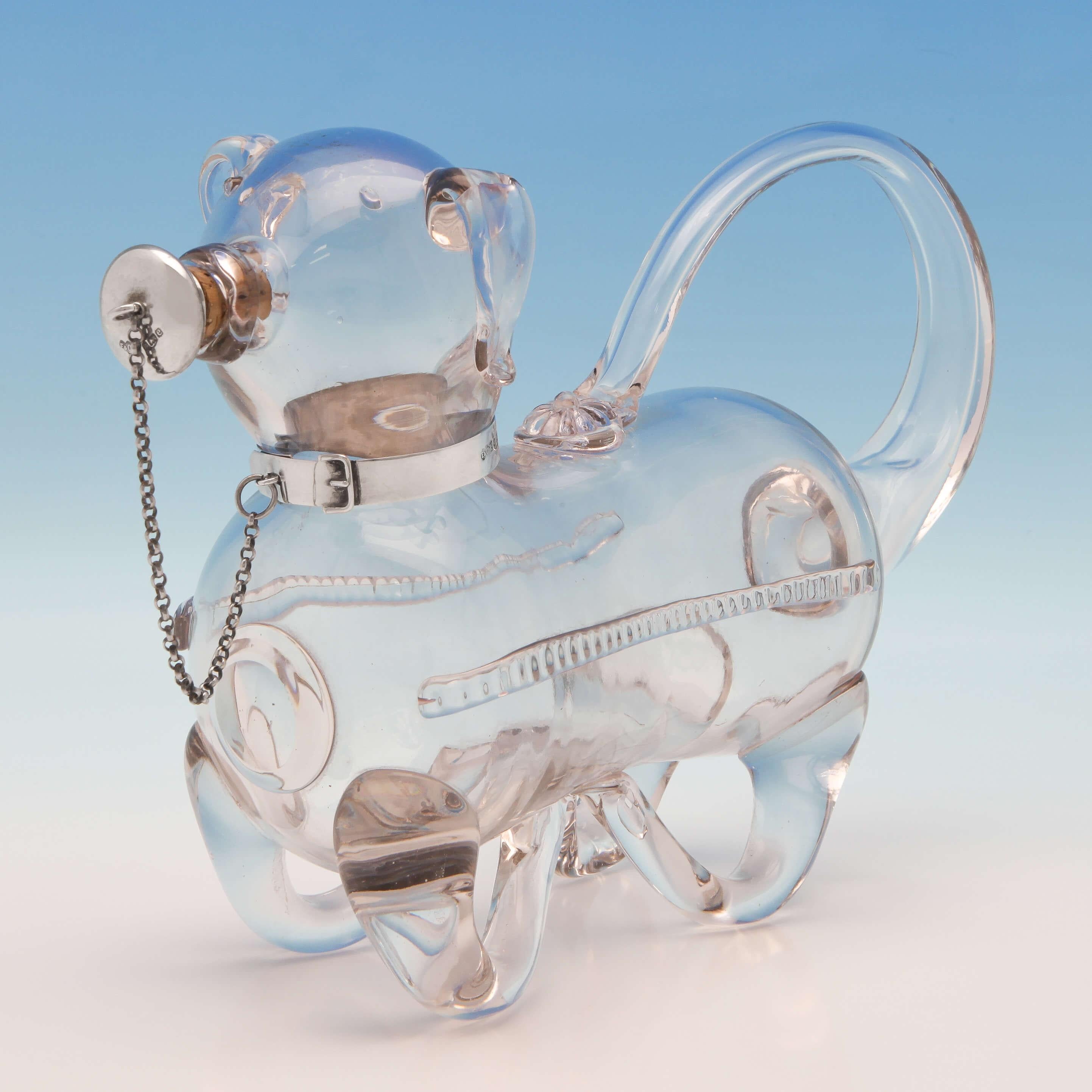 Hallmarked in Birmingham in 1901 by Elkington & Co., this novelty, charming, Victorian, Antique, Sterling Silver Decanter, is designed to look like a pig, with a glass body and a silver collar which is attached to the stopper by a chain. The