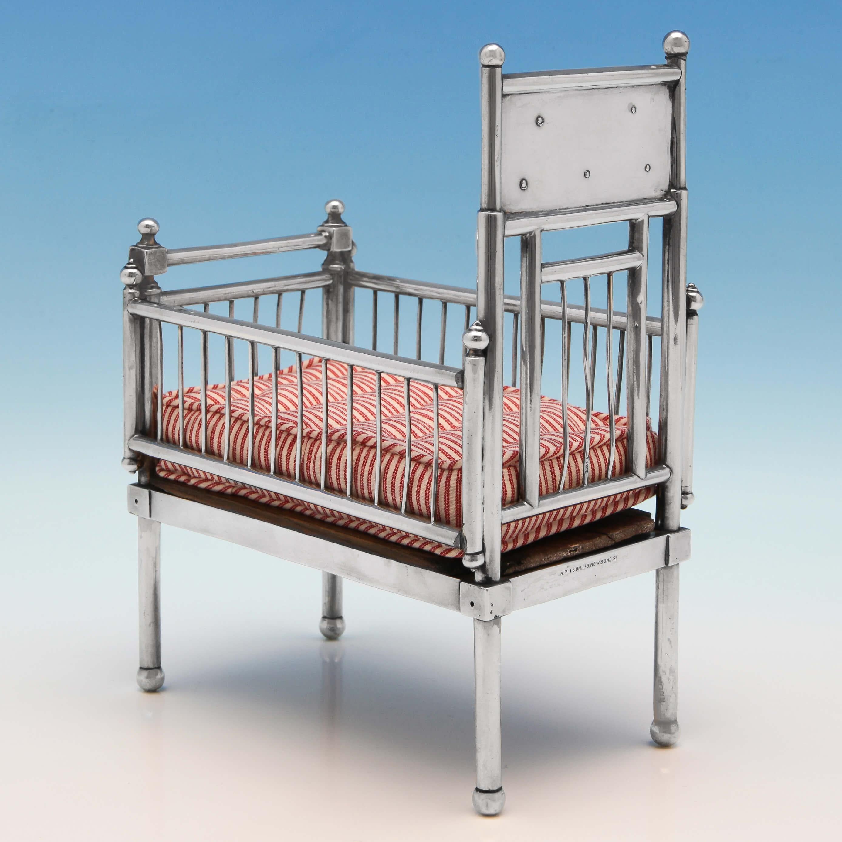 Hallmarked in London in 1902 by William Comyns, this fabulous Edwardian Antique, Sterling Silver Doll's House Cot is very realistic and is presented with a handmade mattress. The headboard bears the words 