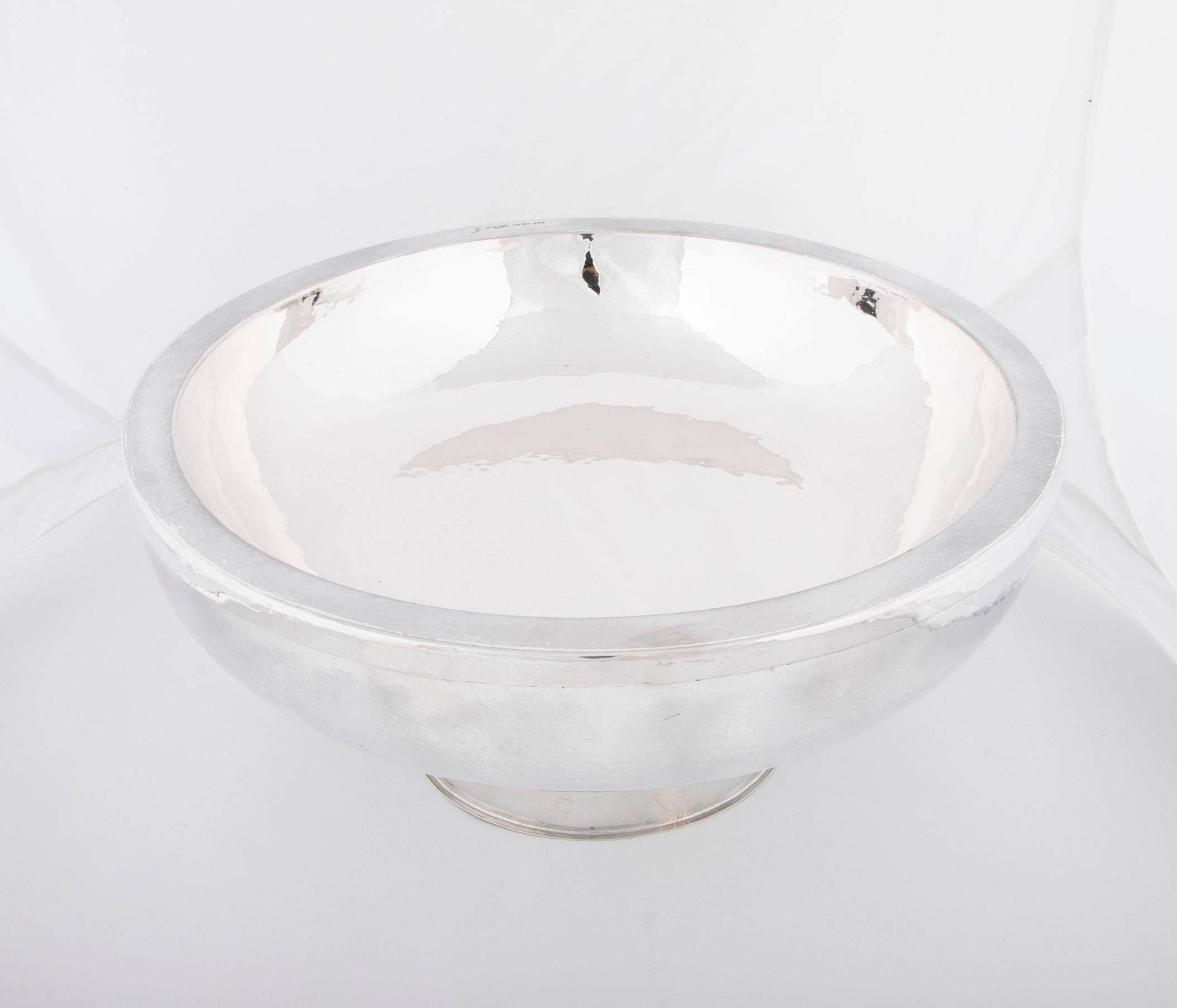 A sterling silver double walled bowl with hand-hammered texture, raised on a circular foot. By Graziella Laffi, Lima Peru, circa 1970.
      