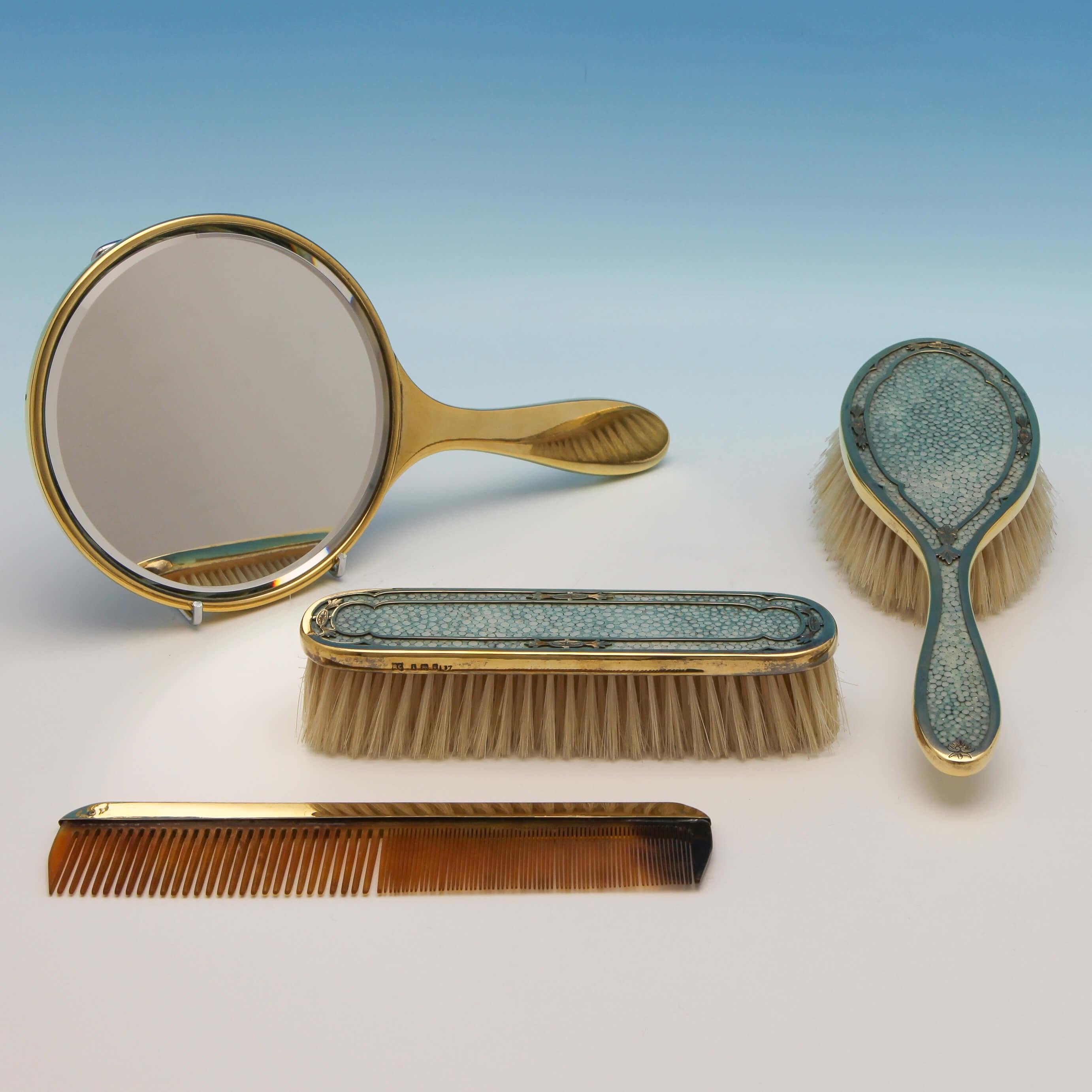 Hallmarked in London in 1926 by Richard Comyns, this attractive, George V, Sterling Silver Dressing Table Set comprises four pieces in a fitted, textured green leather box. The faux tortoiseshell comb has a plain silver gilt overlay. The other