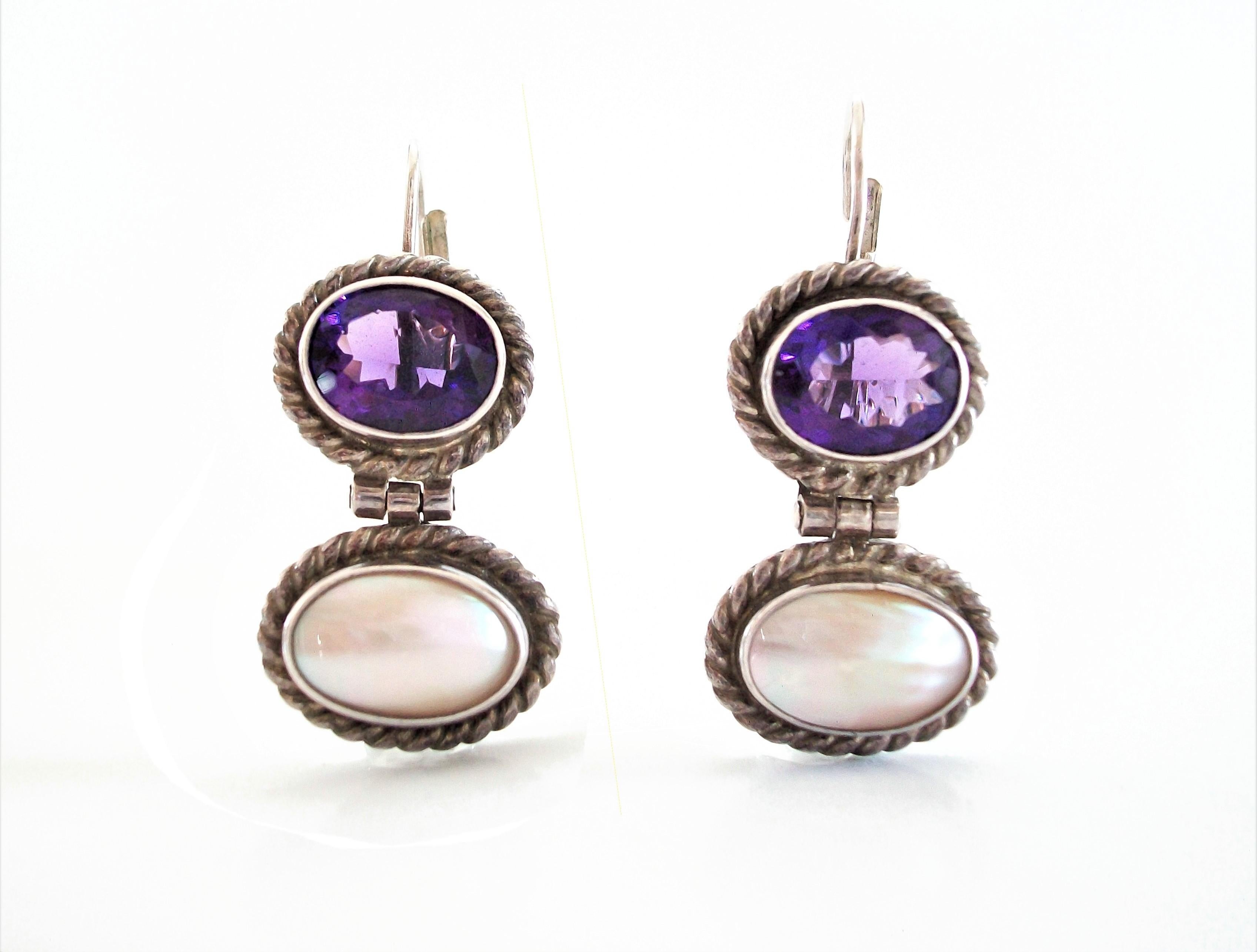 Sterling silver drop earrings for pierced ears - hand made - upper section of each earring bezel set with oval faceted purple Amethyst stones - lower sections with oval bezel set mother of pearl panels - rope twist details surround each section -