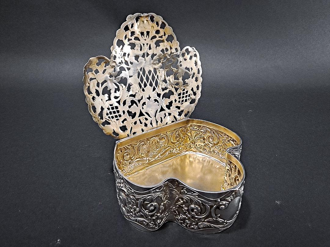 A lovely Edwardian silver trefoil shaped pot pourri or trinket box, chased with flowers, foliage and scrolls. Lid lifts to reveal a gilt interior and has open scrolling and trellis work allowing the air to flow through, so that the perfume can