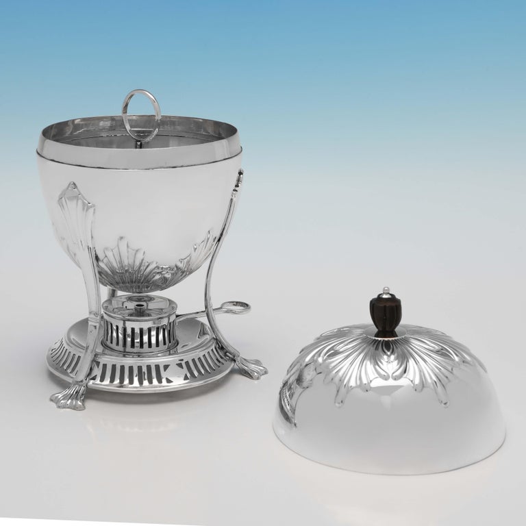 Hallmarked in Sheffield in 1904 by William Hutton & Sons, this handsome, Edwardian, Antique Sterling Silver Egg Coddler, features fluted detail, a wooden finial, a double sided burner for soft and hard boiled eggs, and an internal holder for four