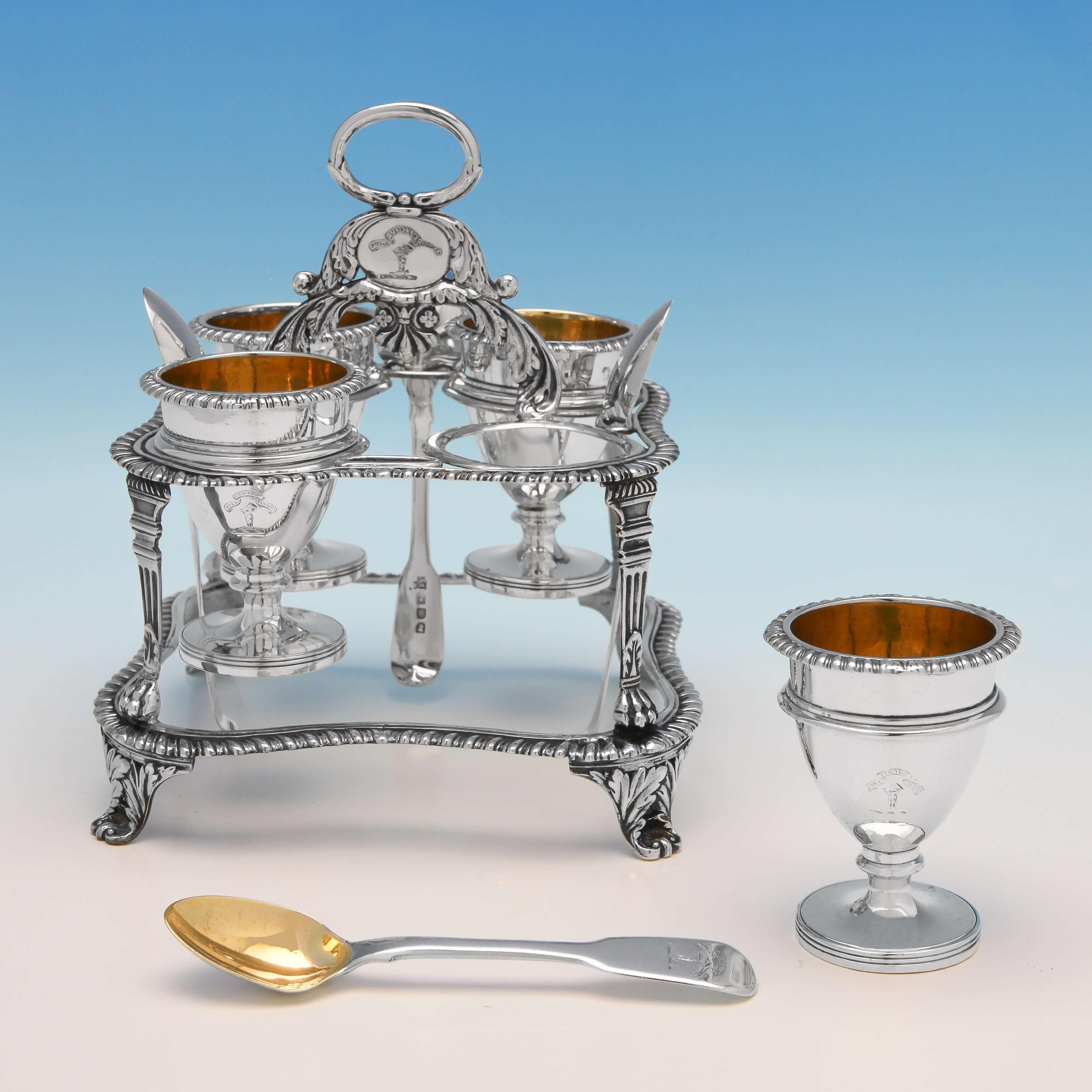 Hallmarked in London, 1816 by Emes & Barnard, with spoons hallmarked in London, 1817 by Ely & Fern, this handsome Antique, Regency, sterling silver egg cruet comprises of four gilt interior egg cups and spoons, housed in a shaped, gadroon border