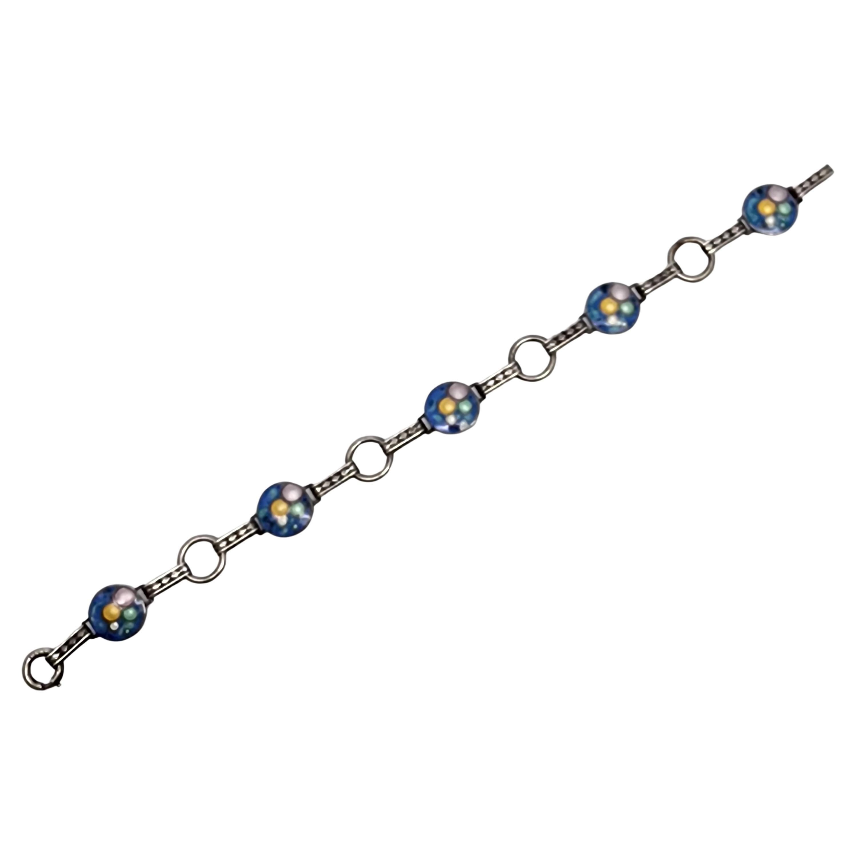 Sterling silver enamel bubble bracelet, circa 1930s.

The introduction of this popular enamel bubble design in the 1930s was to emulate champagne bubbles and the frivolity of the past decade.

Weighs approx 9.1g, 5.9dwt

Measures approx 7