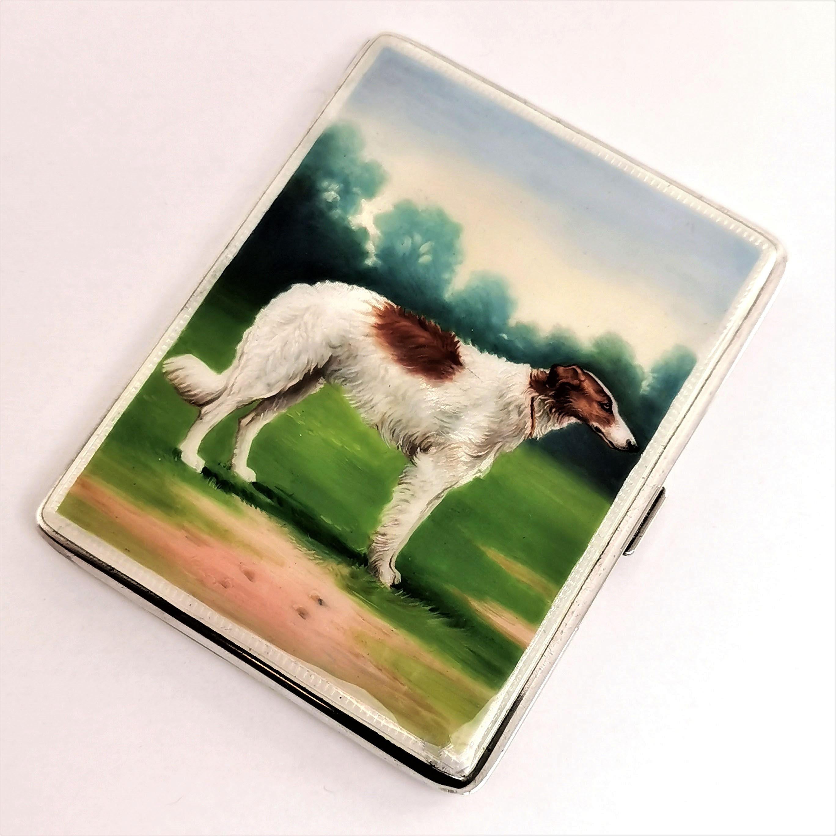 A gorgeous vintage solid silver and enamel cigarette case featuring a beautiful enamel image of a dog on the cover. The image is created in deep, rich colors and with a wonderful attention to detail. The images shows a hunting dog, possibly a Borzoi