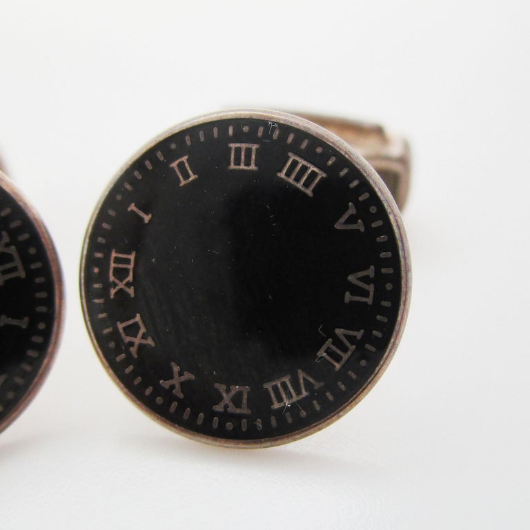 This is an awesome set of links in sterling silver with black enamel panels decorated to look like clock faces. This unique pair of links is perfect for the elegant gentleman who is searching for a set of links unlike any other. The clock face