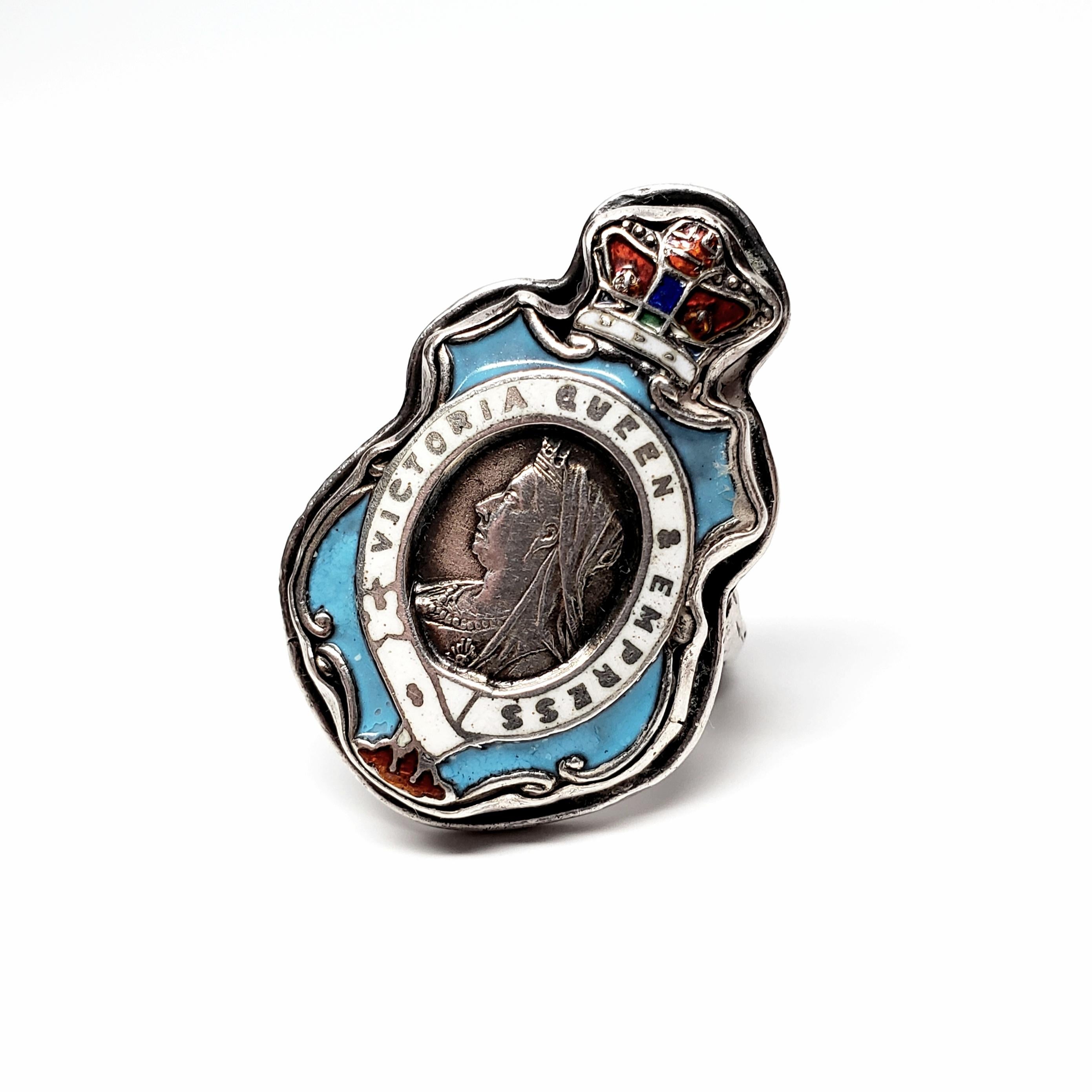 Sterling silver and enamel Queen Victoria Empress Badge ring.

Size 5 3/4

Badge shaped ring with detailed red enamel crown, blue and white enamel accents, 