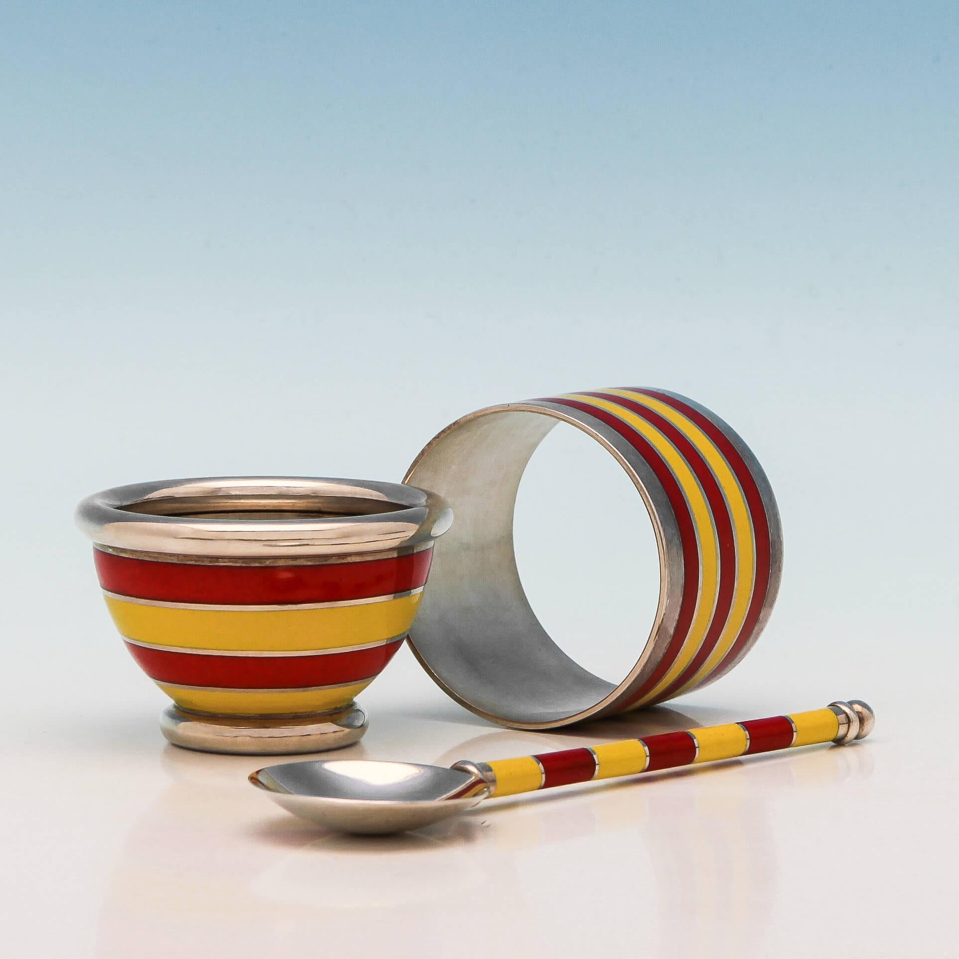 Hallmarked in London in 1995, this fabulous, modern, Elizabeth II, sterling silver child's set comprises of an egg cup, an egg spoon and a napkin ring, decorated with yellow and red striped enamel and presented in a fitted box. The egg cup is