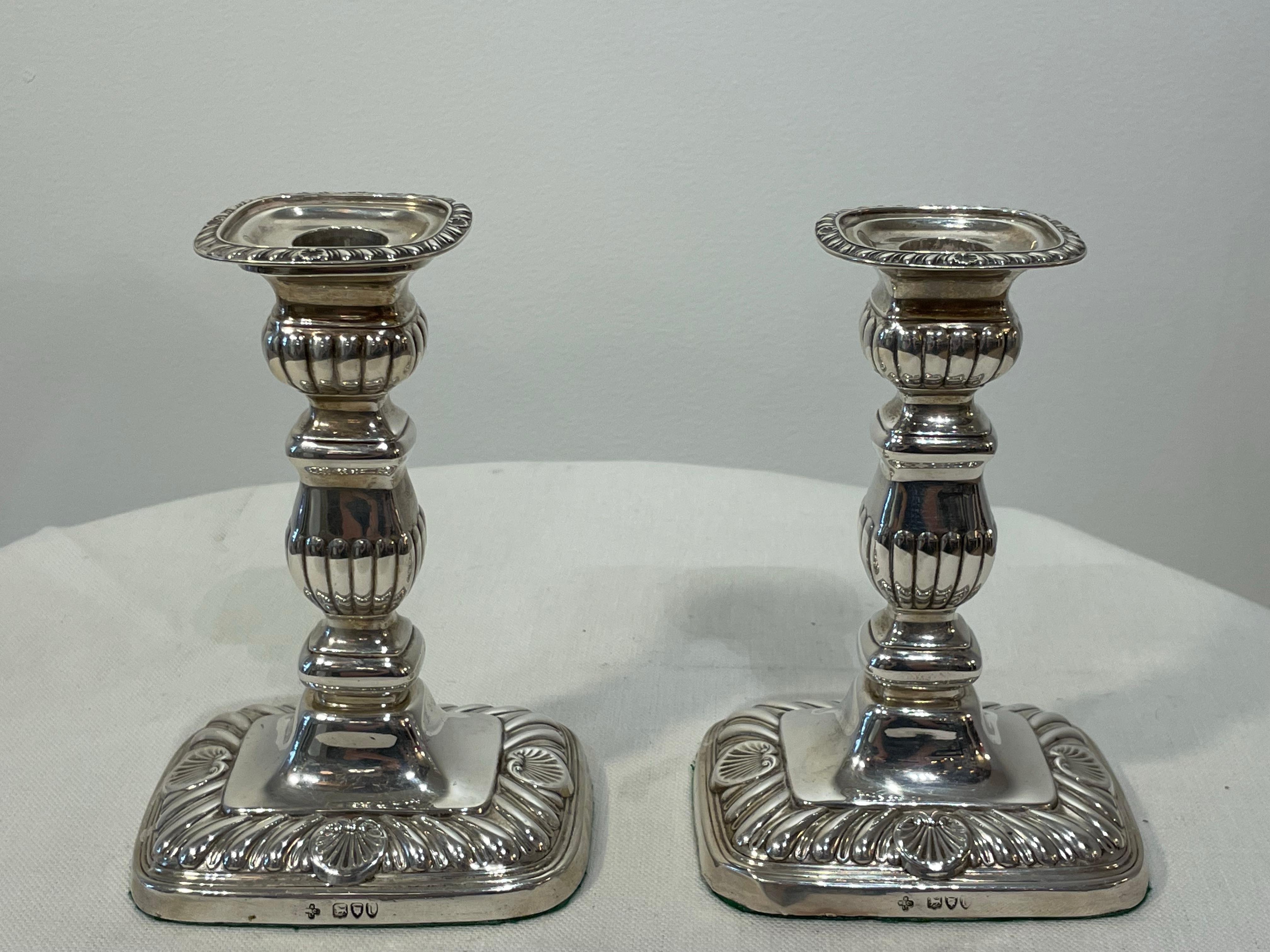 English silver chamber candlesticks in the Georgian style. Hallmarked and stamped. Late 19th century.