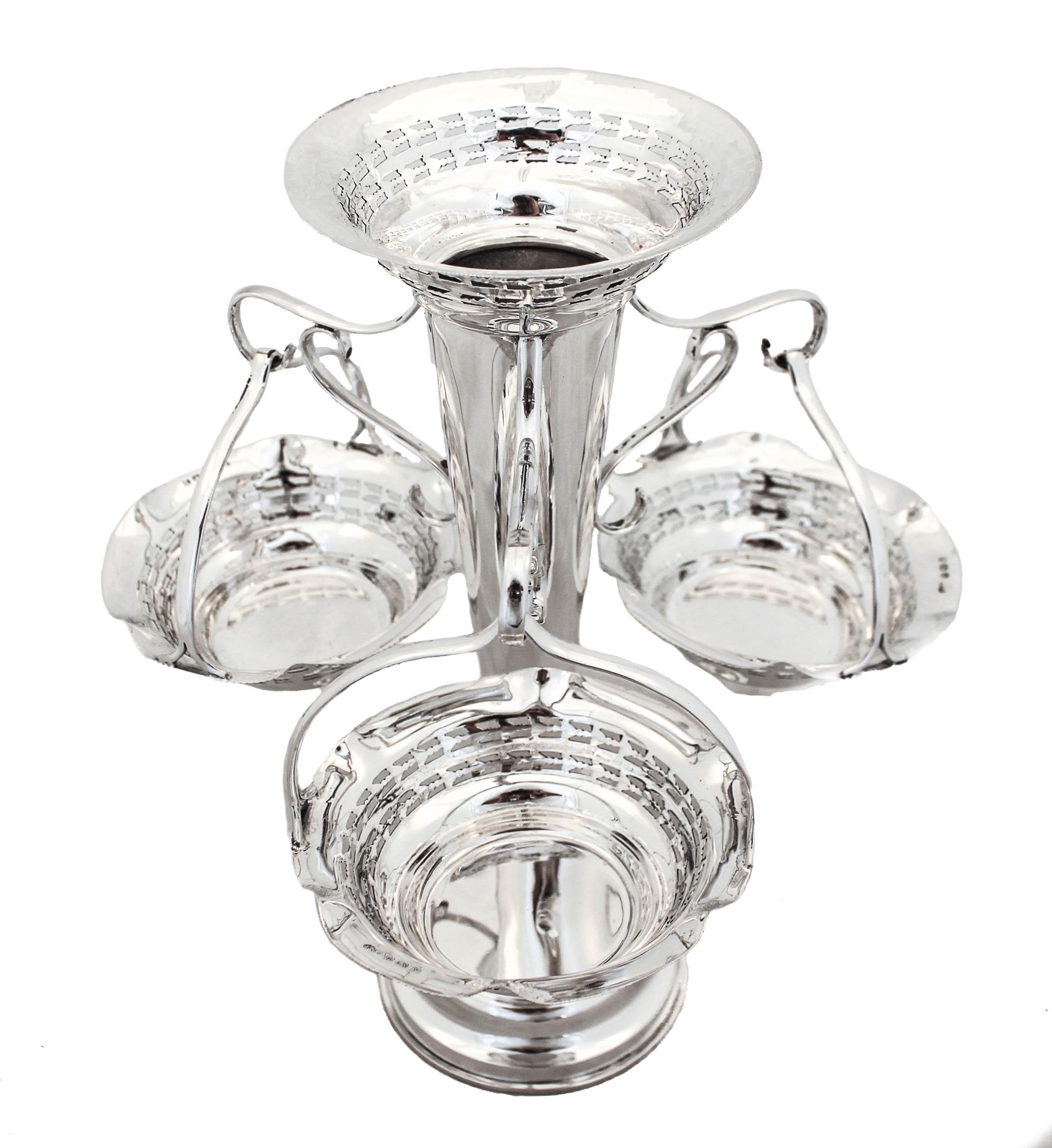 We are thrilled to offer you this rare sterling silver epergne made in Birmingham, England circa 1923. An epergne is an ornamental centerpiece for either a dining or coffee table, typically used for holding sweets and flowers. This epergne has a