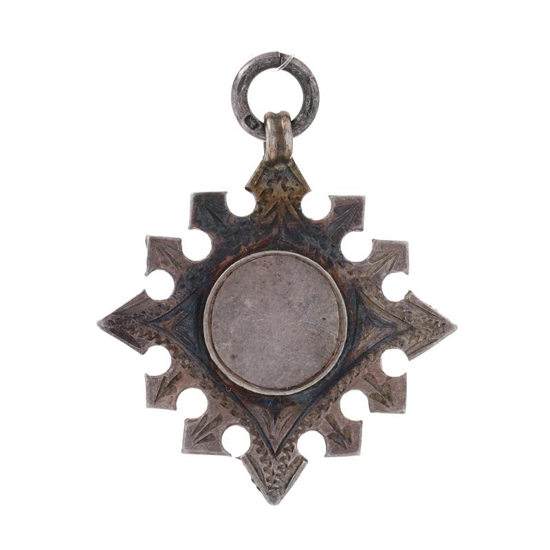 Brand: Herbert Bushell & Son Ltd
Date: 1912 - 1913

Metal Content: Sterling Silver

Style: Fob
Features: Engravable centers with etched borders

Measurements
Tall (from stationary bail): 1 13/32