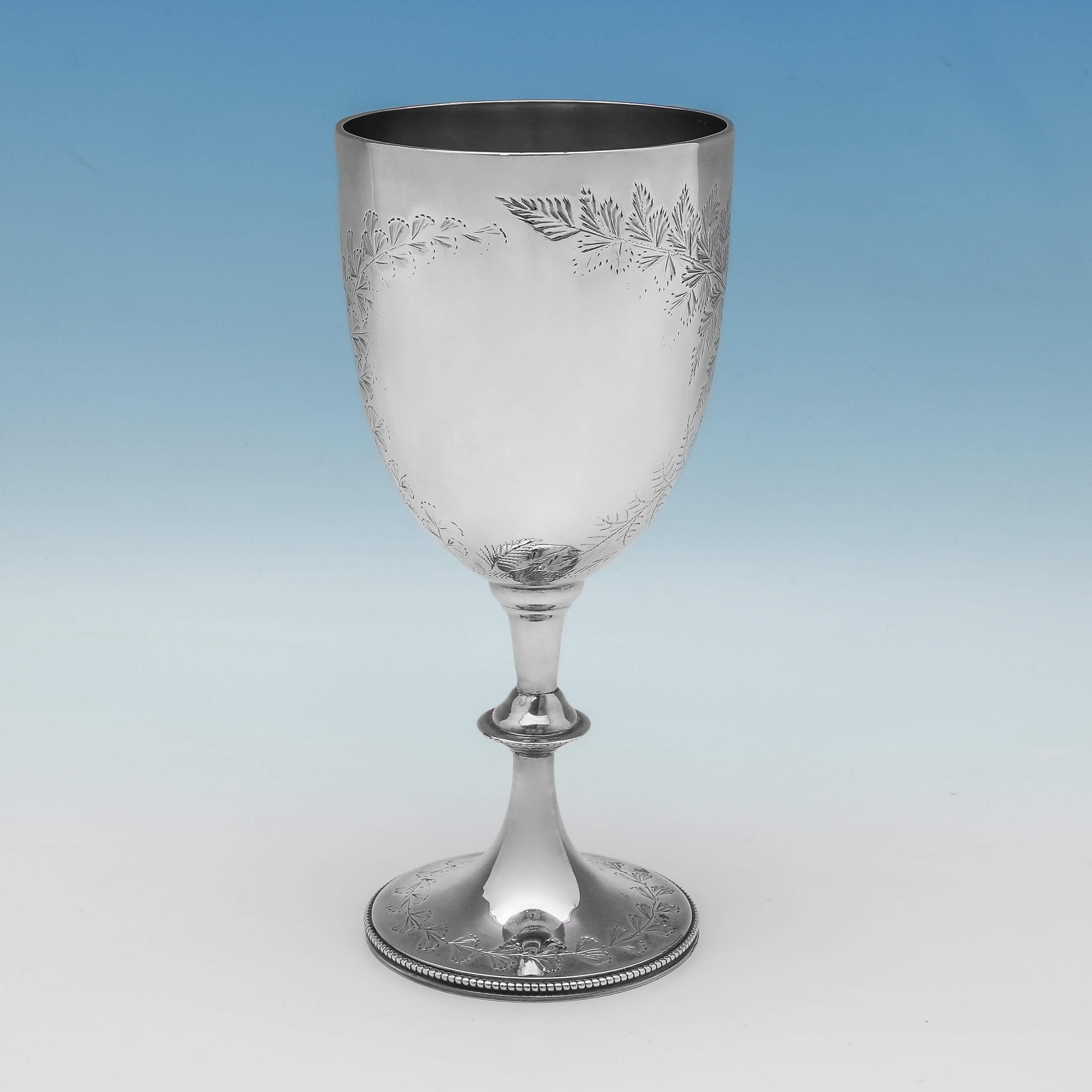 Hallmarked in London in 1892 by Charles Stuart Harris, this attractive, Victorian, antique sterling silver goblet, features bright cut engraved foliage decoration and a bead border around the foot. The goblet measures 7
