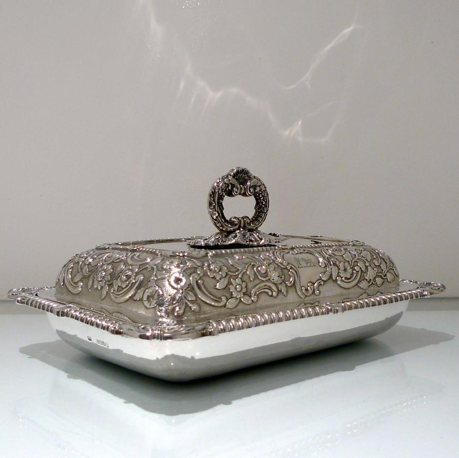 A very stylish original chased late Georgian oblong silver entree dish decorated with truly impressive floral embossing to the upper dish (cover) which is then set on a matt background for contrast. The lower dish (base) is plain formed in design to