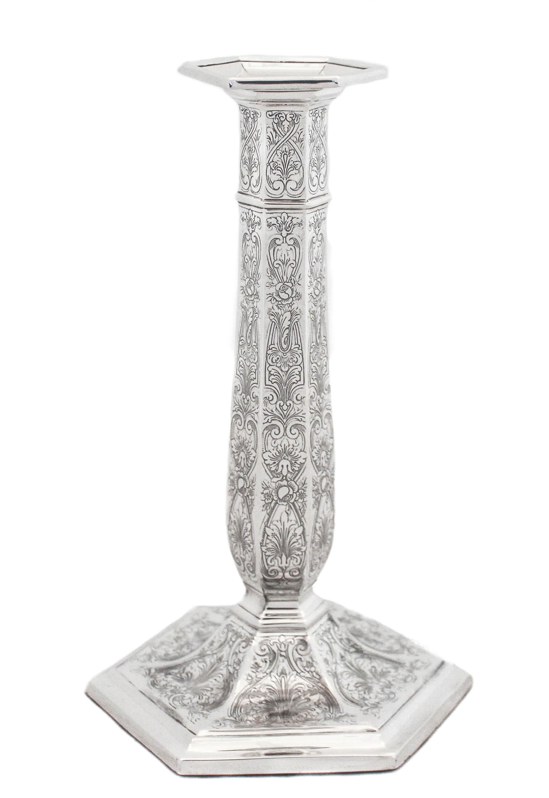 Being offered is a stunning pair of sterling silver candlesticks by Reed and Barton. The workmanship is simply breathtaking. Scrolls, fans, flowers and leaves come together in this design. All the etching around the base and along the body is in